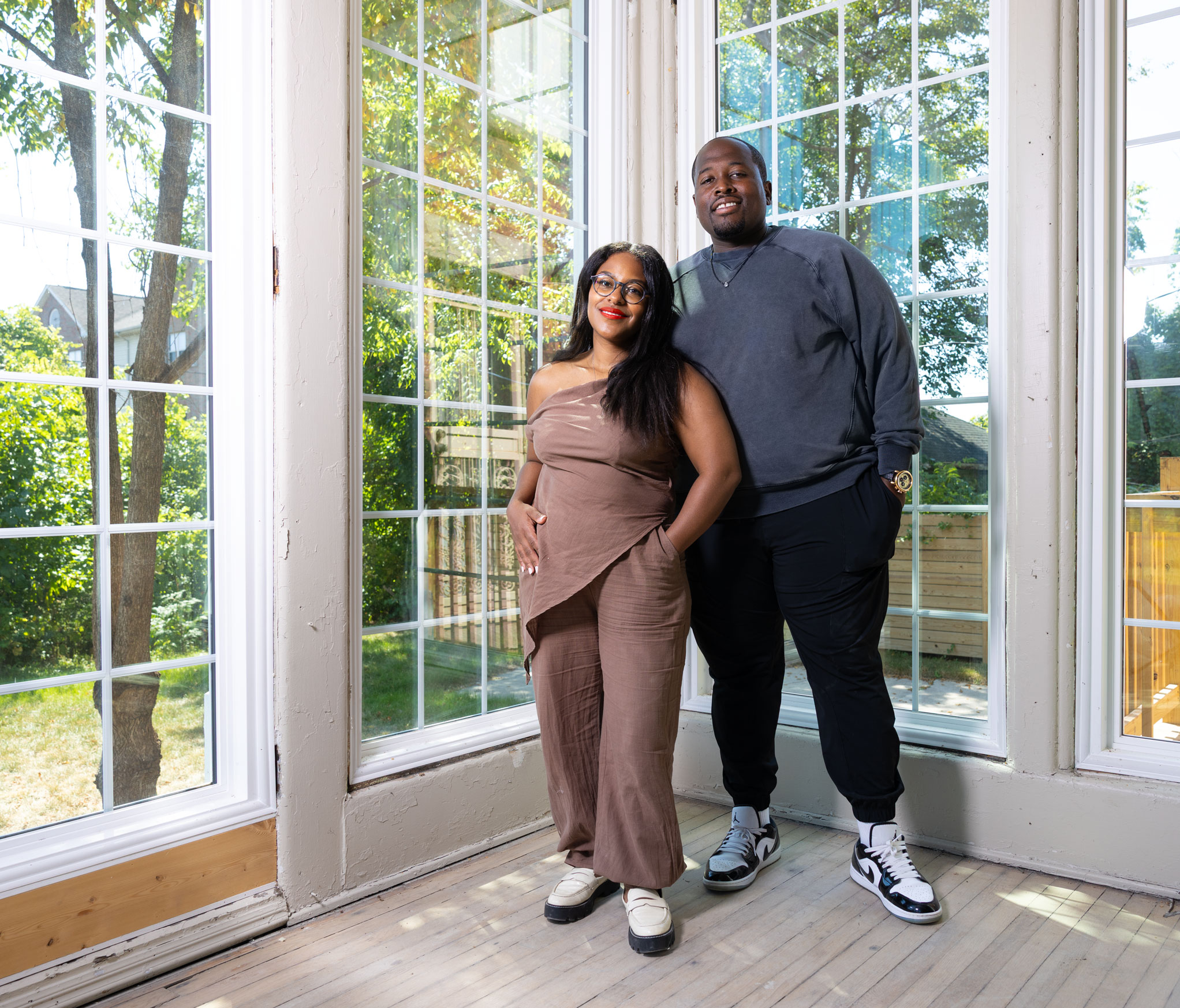 photo of the Greens in their home with floor to ceiling windows by Michael Lewis