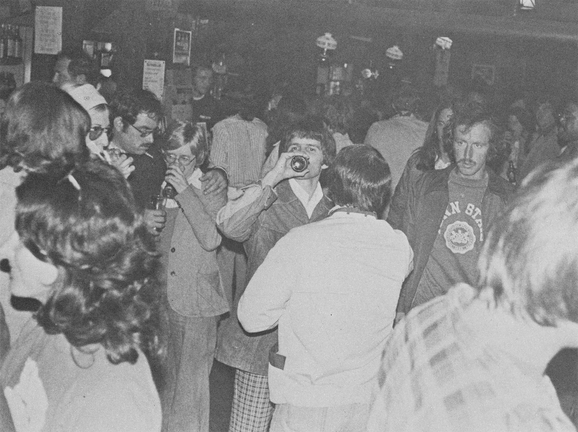 black and white photo of students dancing and drinking at the Rathskeller, by Penn State Archives