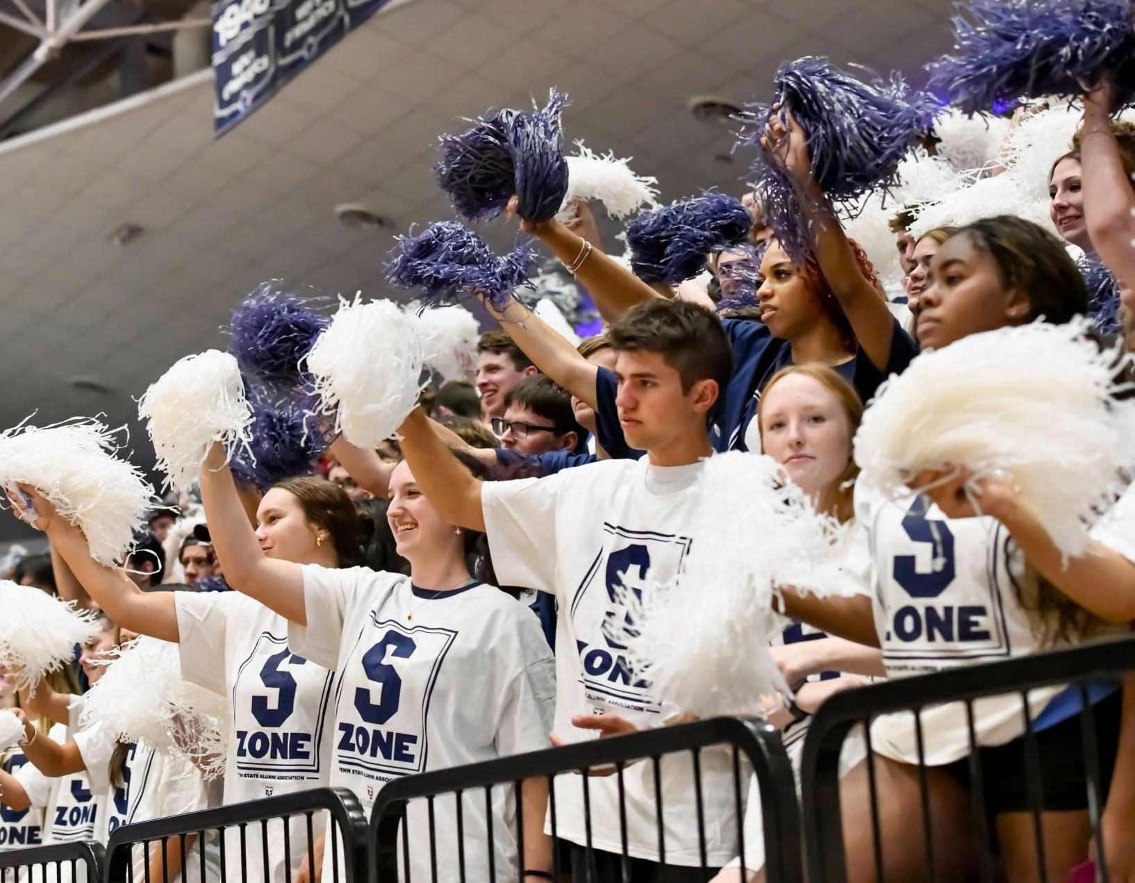 photo of students in Rec Hall wearing S Zone shirts and waving shakers at Be a Part From the Start, by Penn State Alumni Association