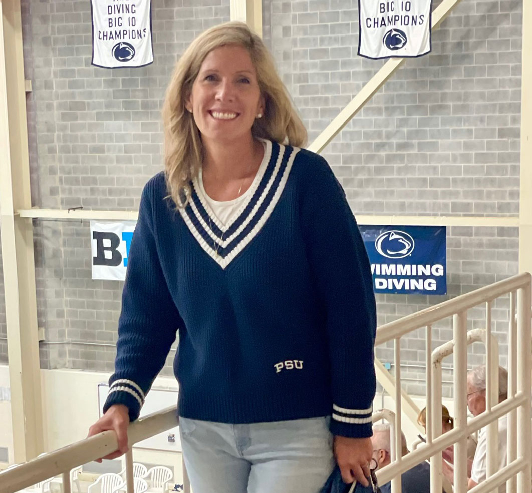 photo of Collins in Penn State apparel standing above pool, courtesy
