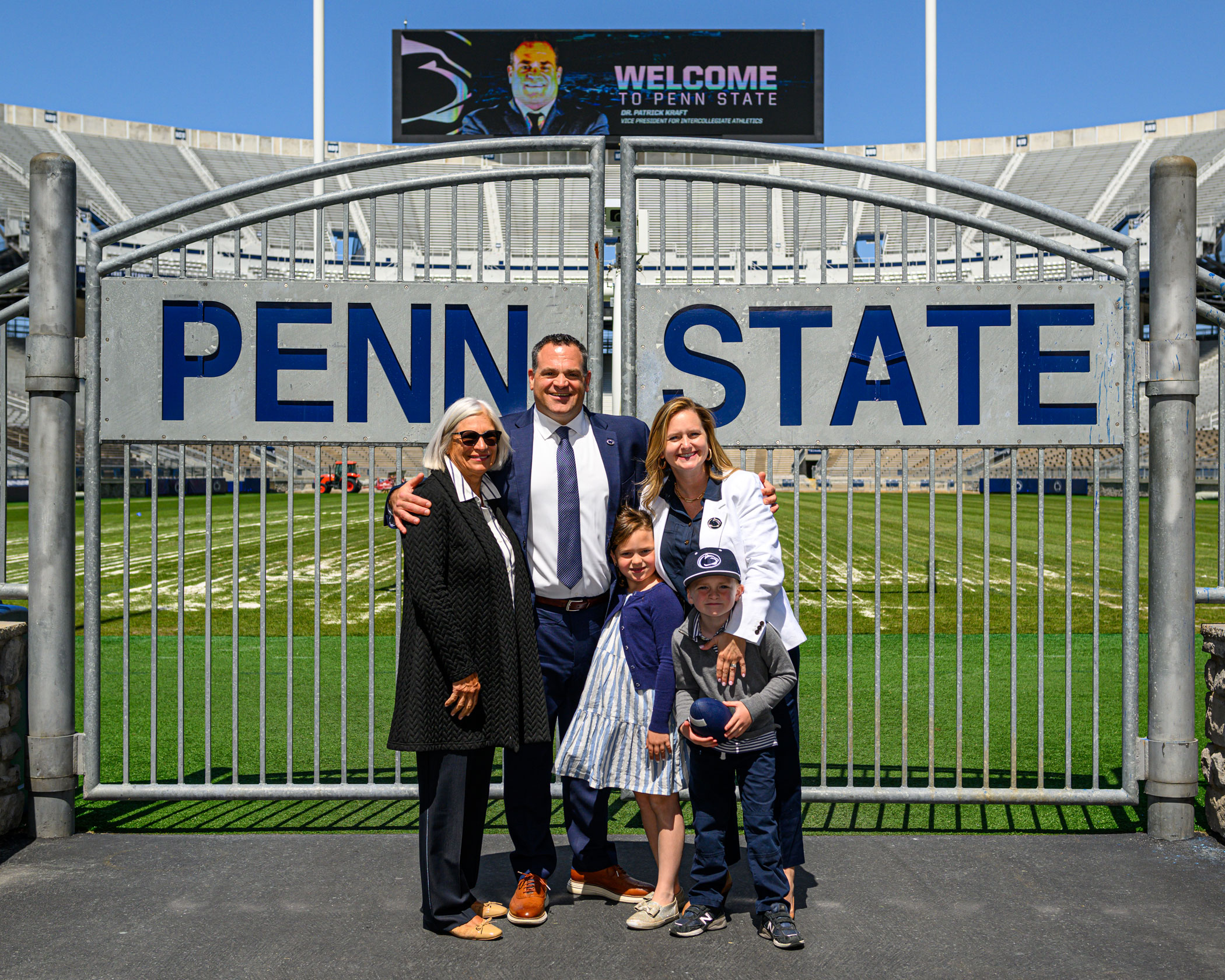Pat Kraft and family posing in front of Beaver Stadium gate, photo by Mark Selders / Penn State Athletics