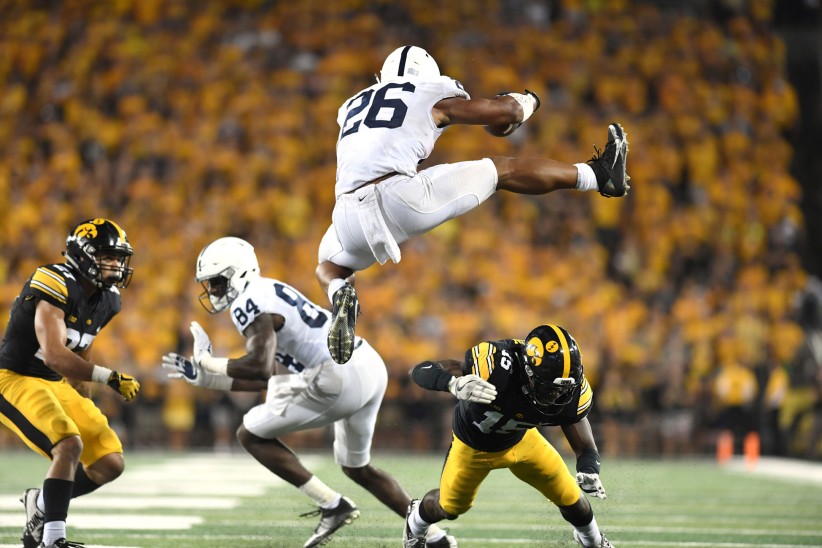 Barkley jumping over Iowa defender, photo by Steve Manuel ’84 Lib, ’92 MA Com