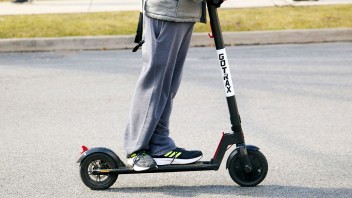 a helmeted student riding an electric scooter, photo by Steve Tressler