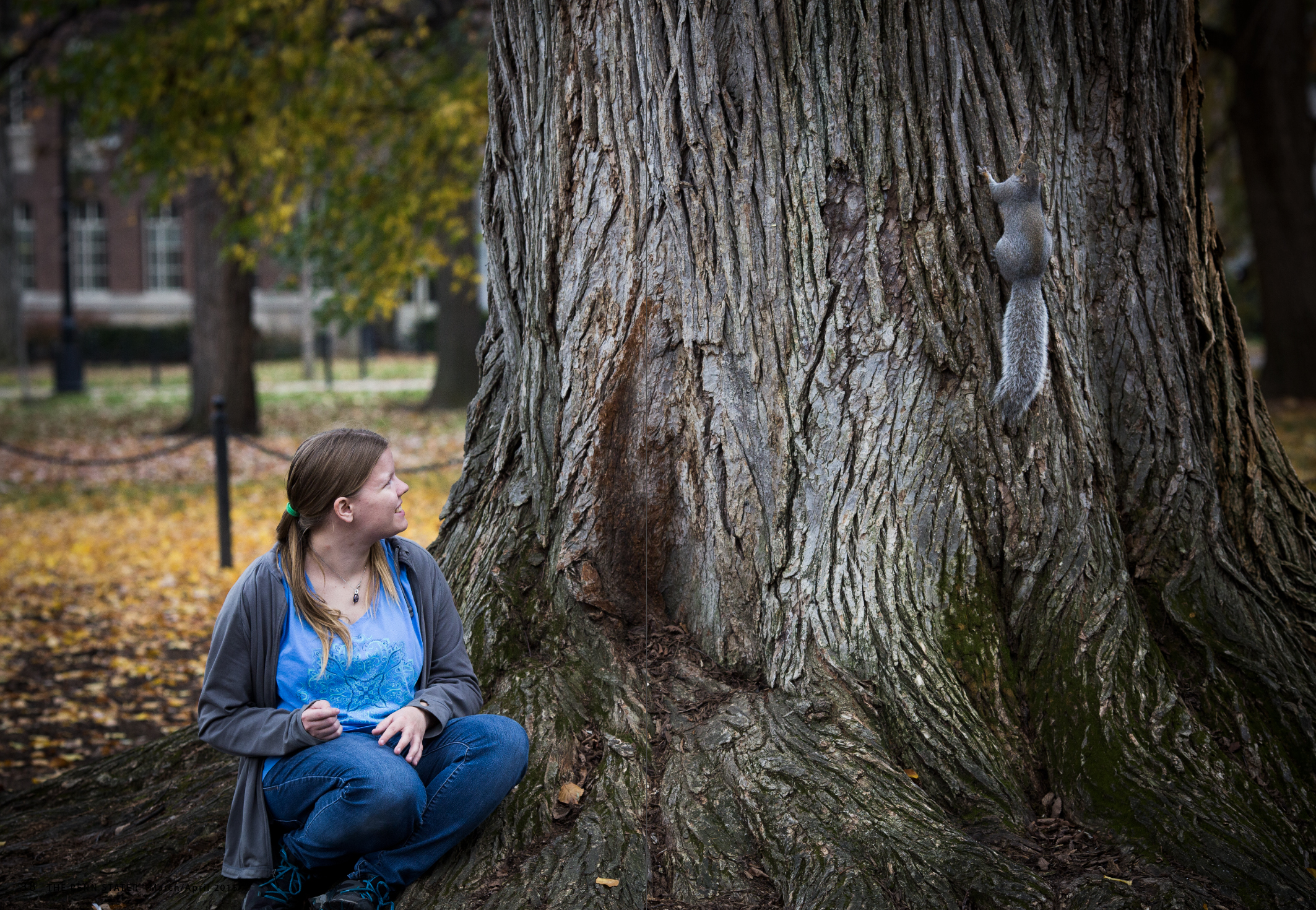 Mary Krupa sitting beside Sneezy's tree