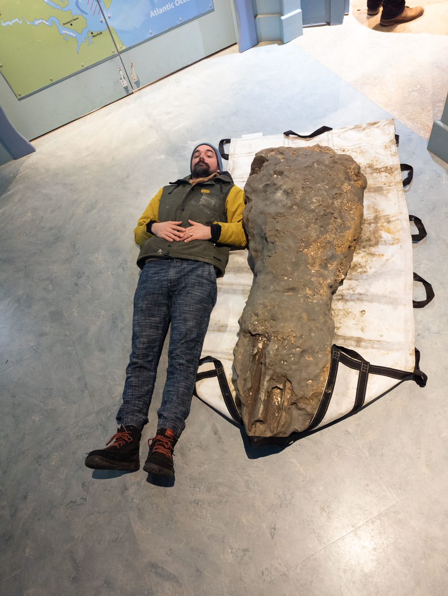 photo of Goddard lying alongside a whale skull he found, courtesy