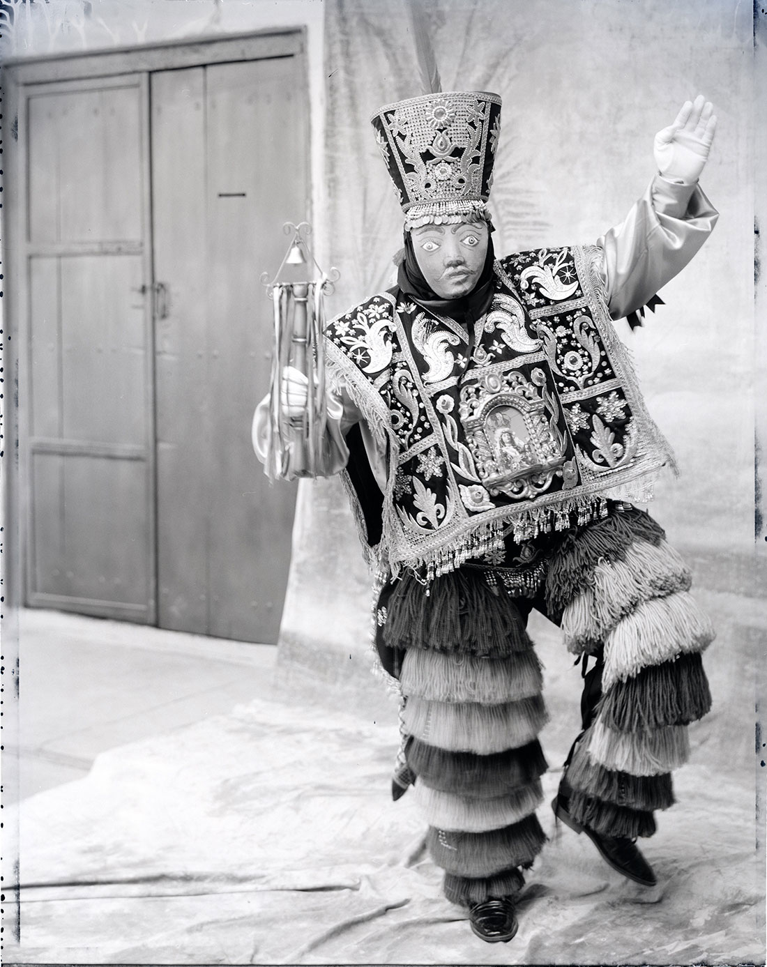Lonnie Graham's black and white portrait of a costumed reveler in Peru