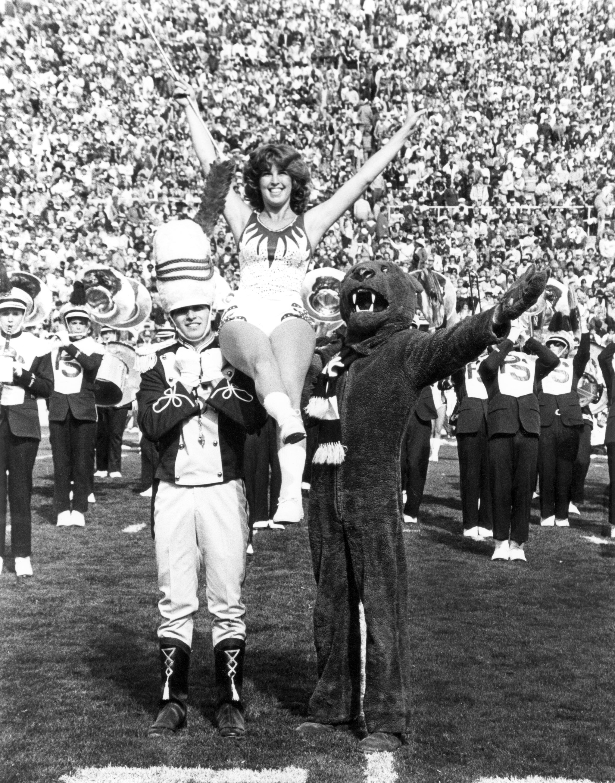 black and white photo of the first Blue Sapphire twirler with the Lion and the drum major in 1981, by Penn State Alumni Association Archives