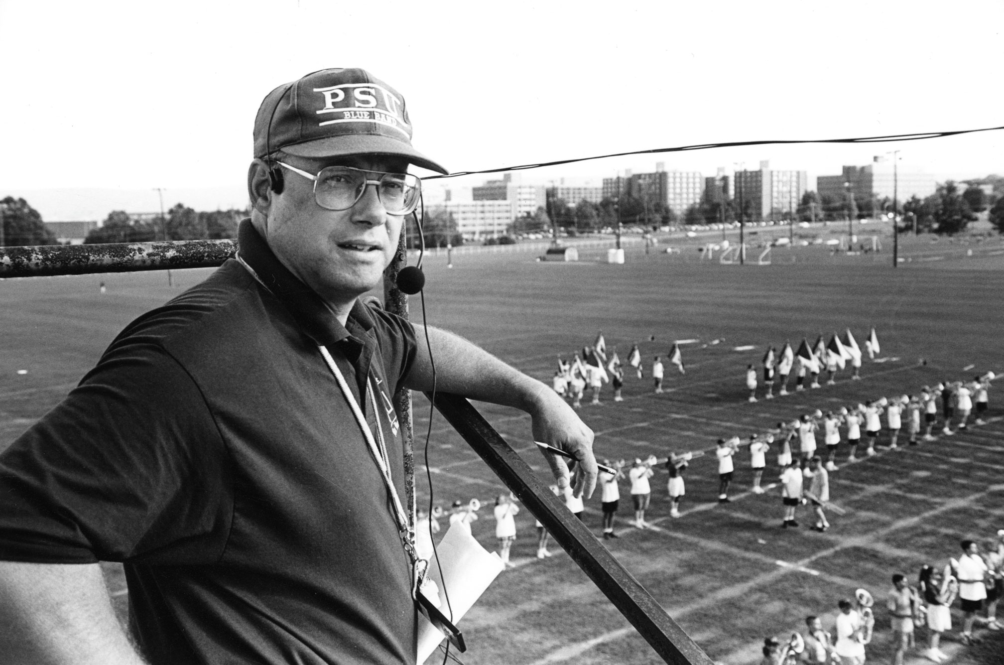 Black and white photo of band director O. Richard Bundy overseeing a mid-90s dress rehearsal by Penn State Archives