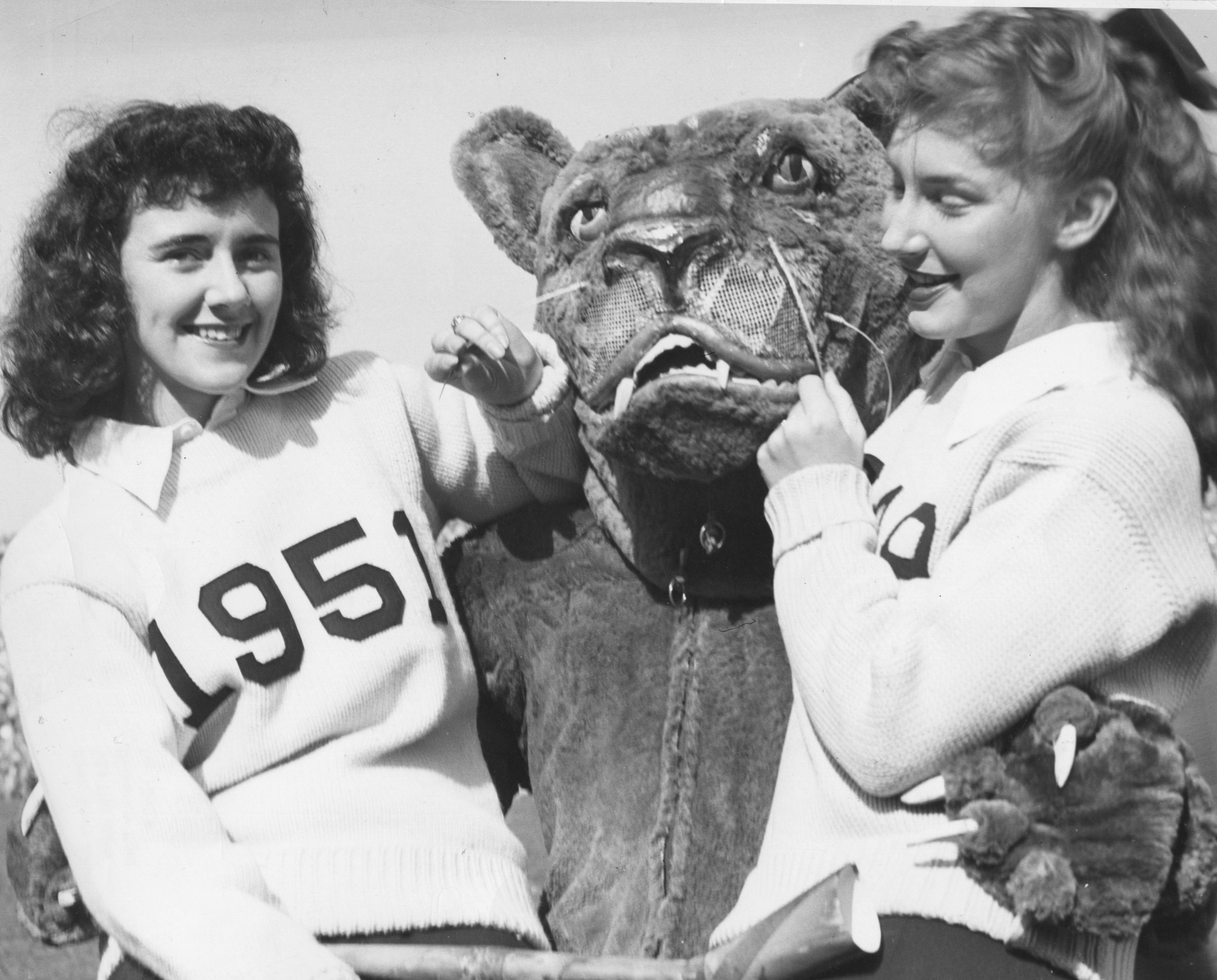 black and white photo of the Nittany Lion with cheerleaders