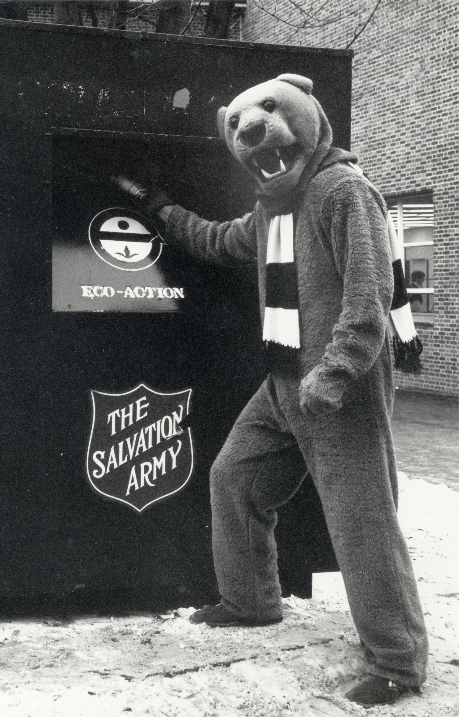 black and white photo of the Nittany Lion recycling in a large Salvation Army drop box in 1977