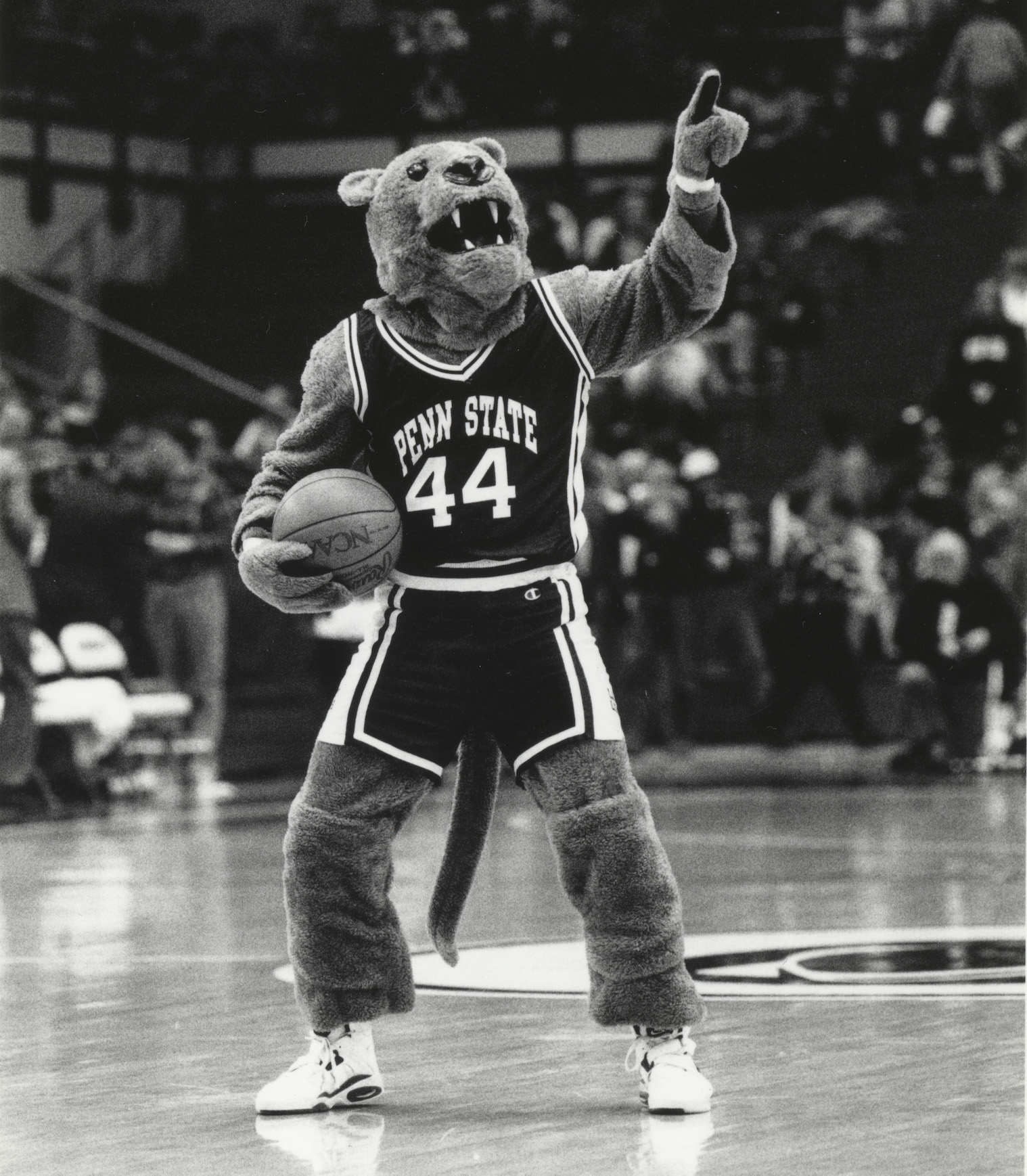 black and white photo of the Nittany Lion on the basketball court