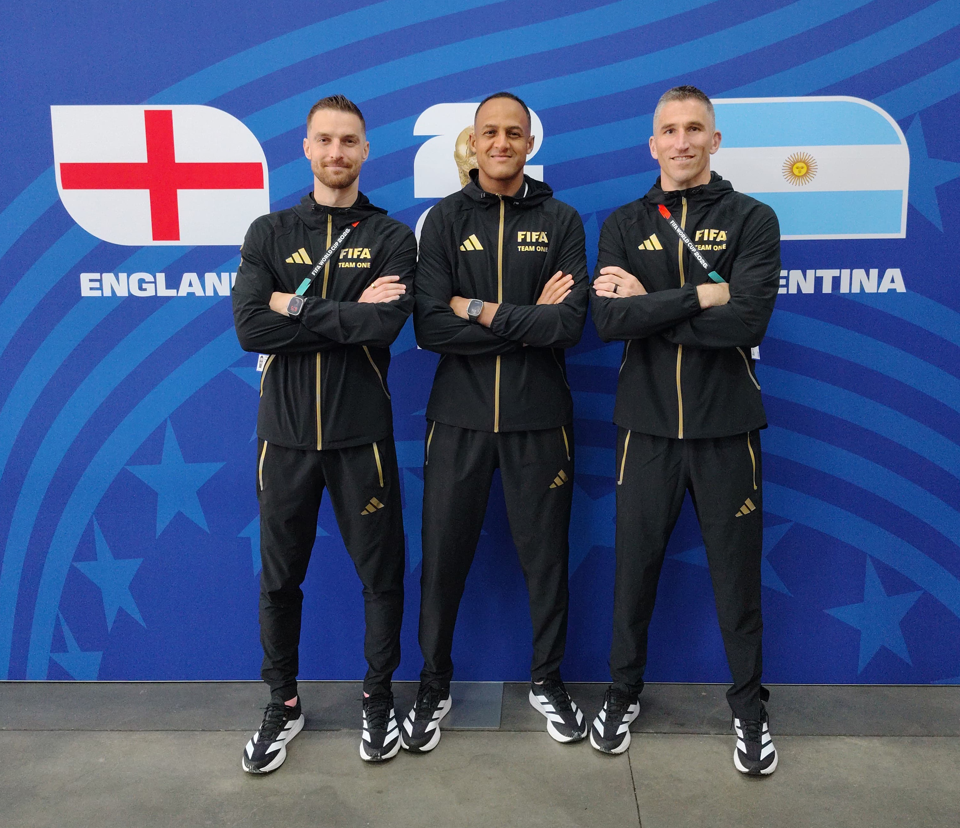 Parker, Elfath, and Atkins before FIFA flags, courtesy