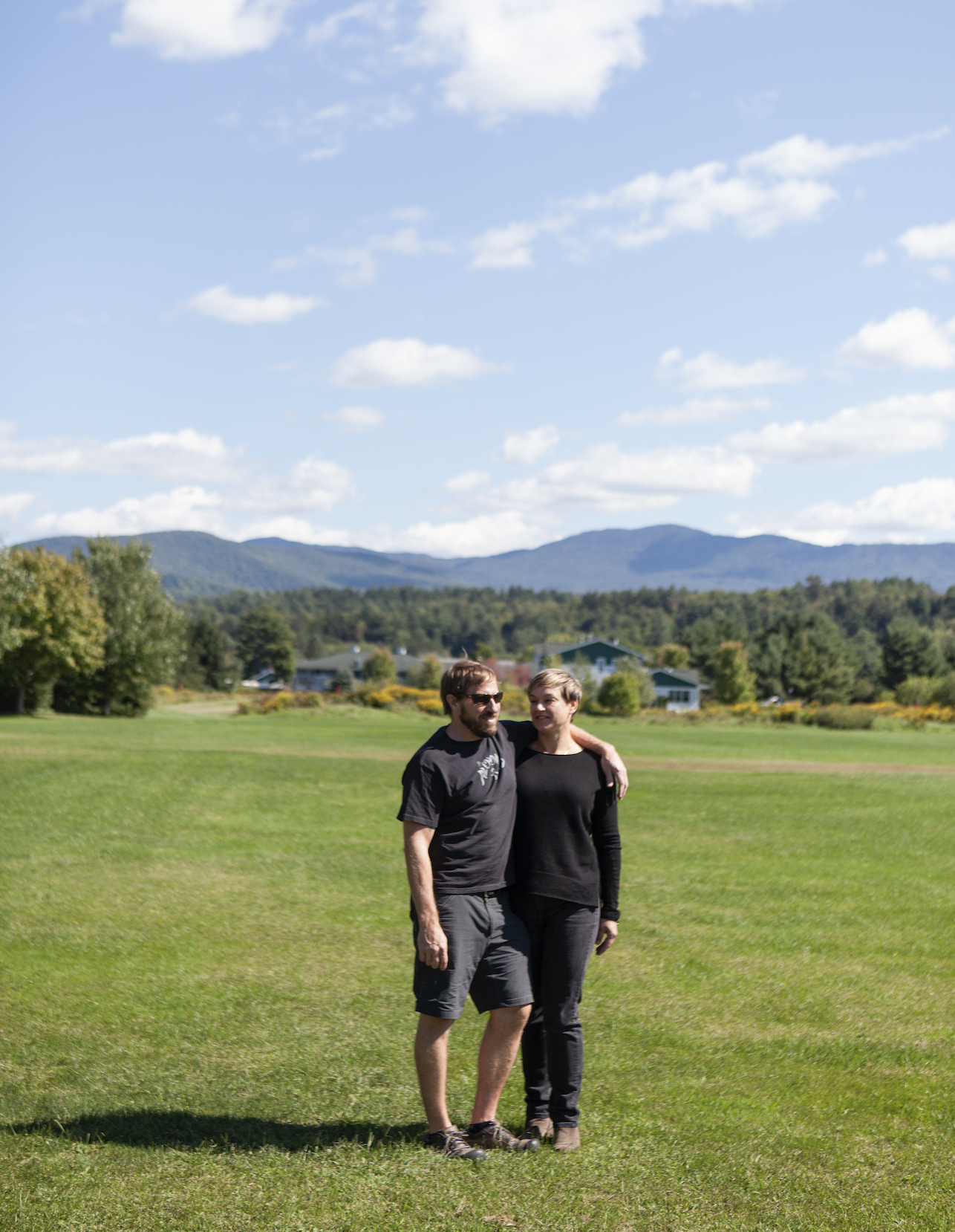 Kimmich and wife and business partner Jen standing with arms around each other in green grass field, courtesy