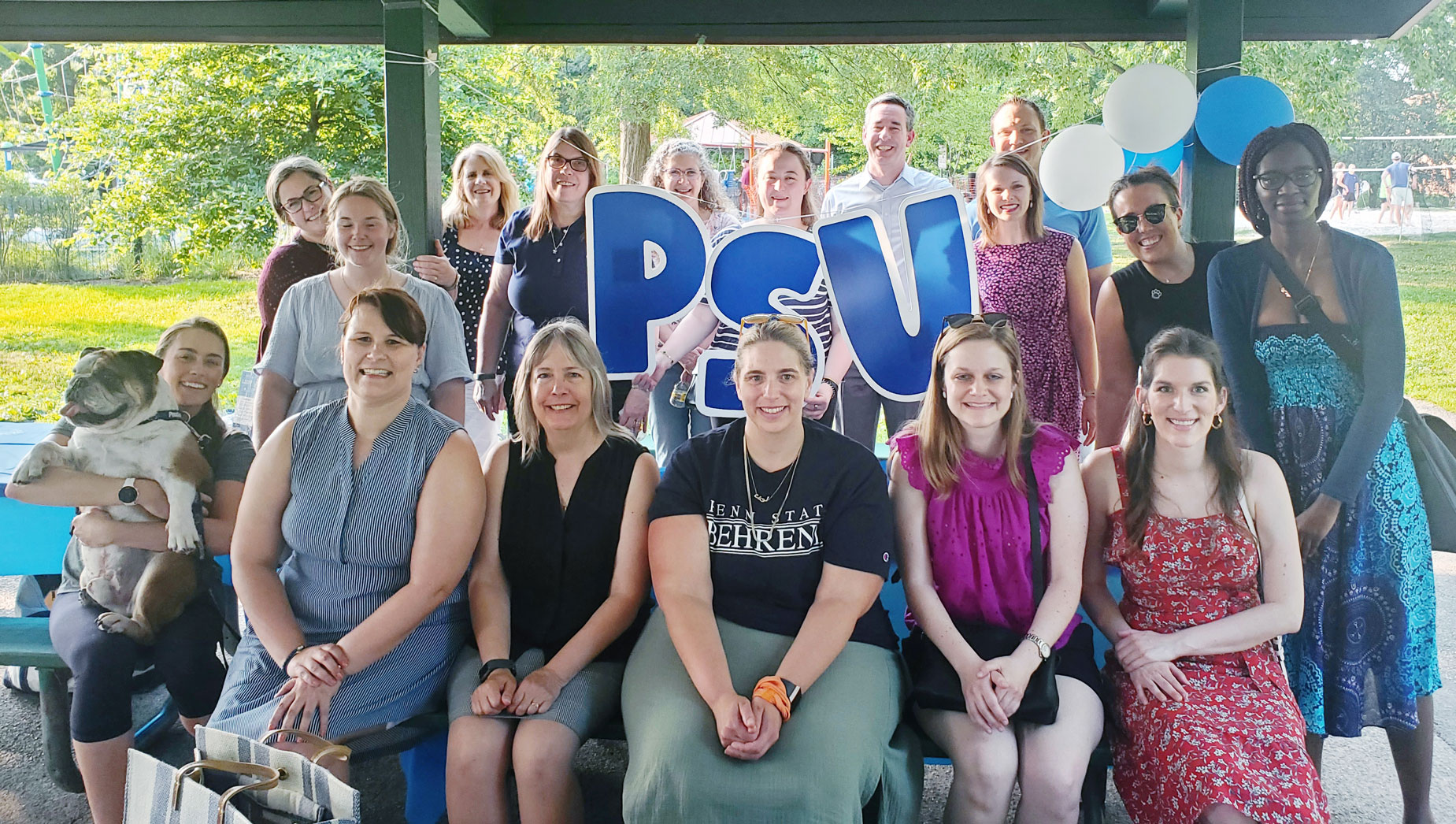 photo of alums with white and blue balloons and blue PSU sign, courtesy Alumni Career Services