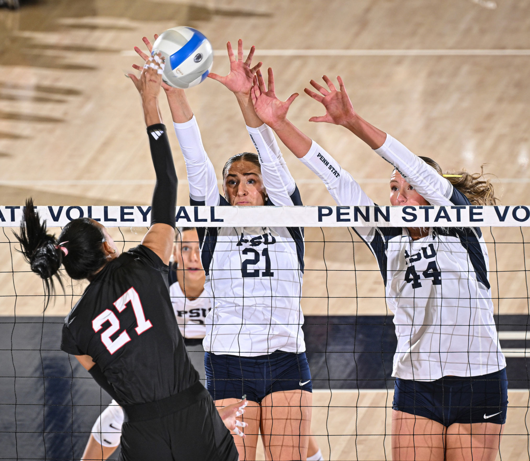 Nittany lion women's volleyball players in action against Nebraska, photo by Penn State Athletics