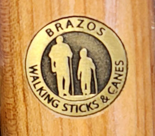 closeup of Brazos Walking Sticks and Canes logo on a walking stick, courtesy