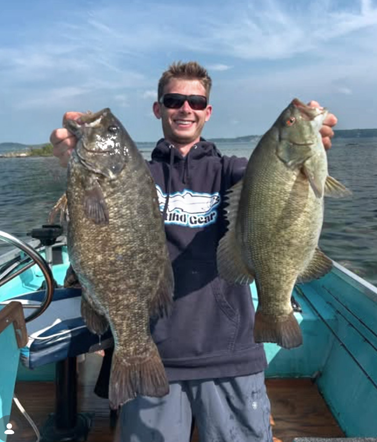 Leahy holding up two bass, courtesy