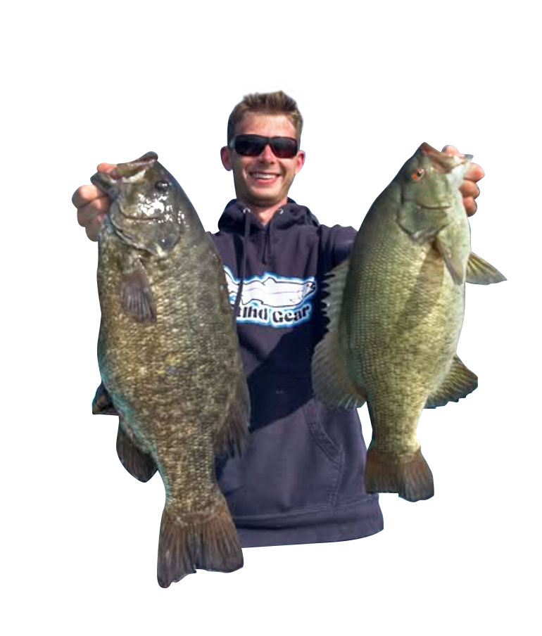 Leahy holding up two bass, courtesy
