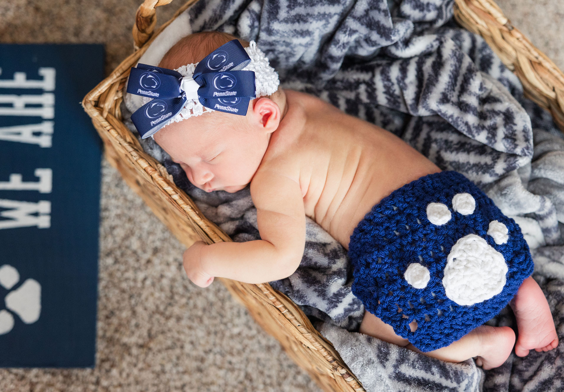 sleeping baby wearing crocheted Penn State shorts with Penn State ribbon headband, courtesy