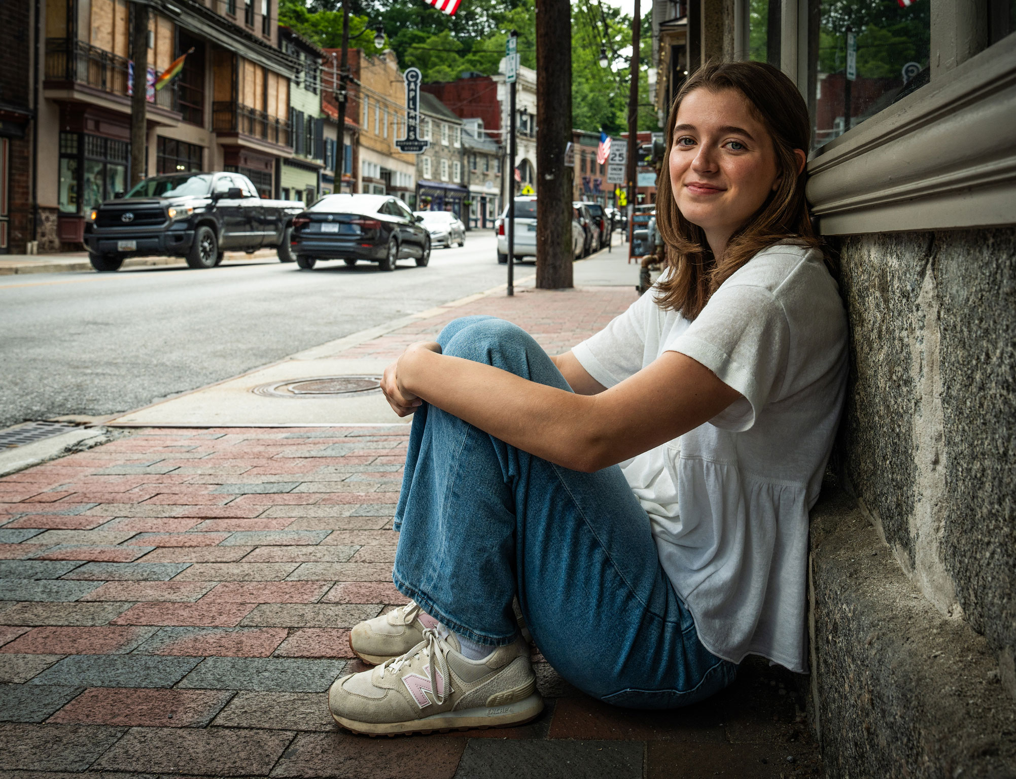 photo of Conrad seating outside on sidewalk leaning against a building by Cardoni