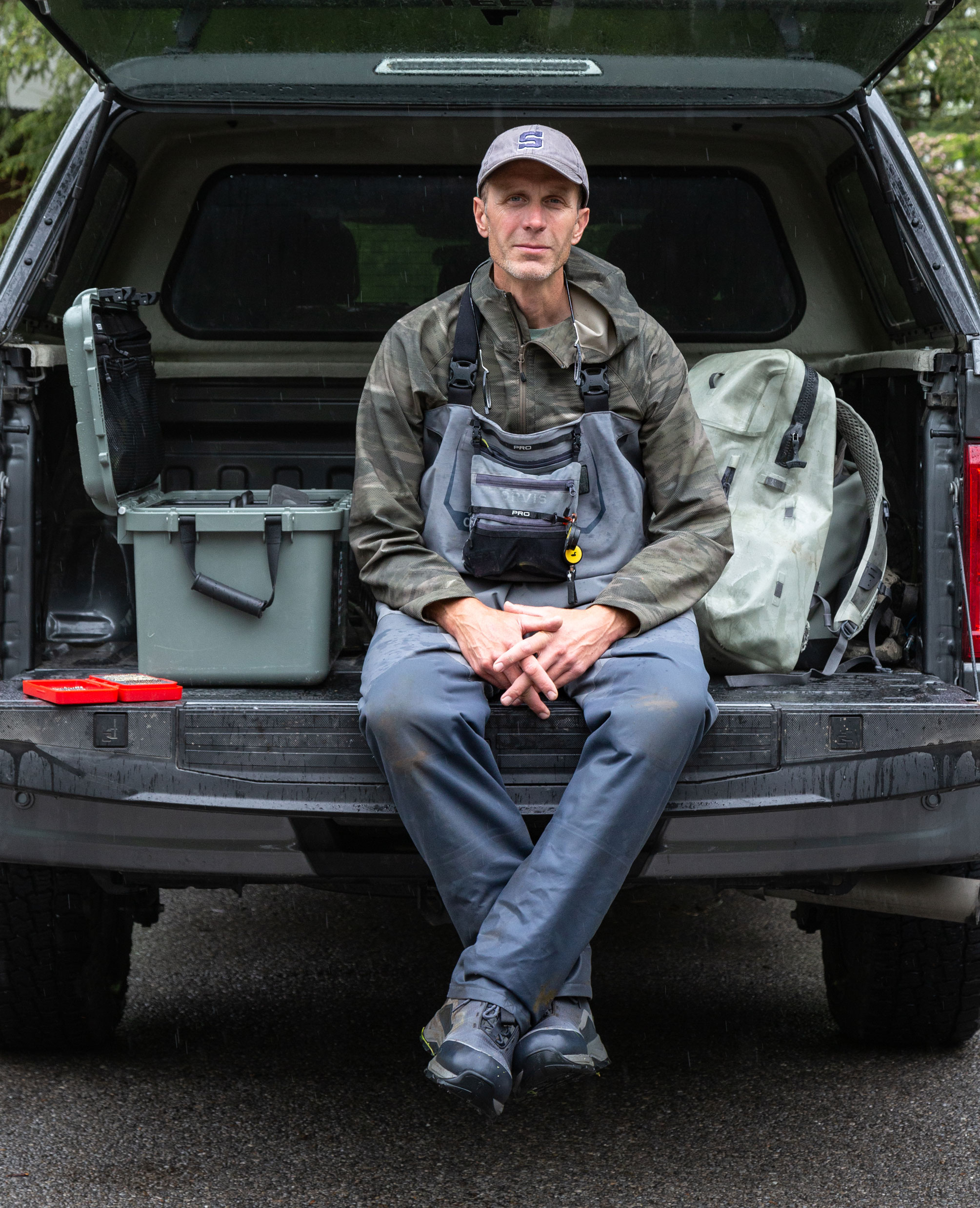 George Daniel sitting on the tailgate of his vehicle, photo by Nick Sloff '92 A&A