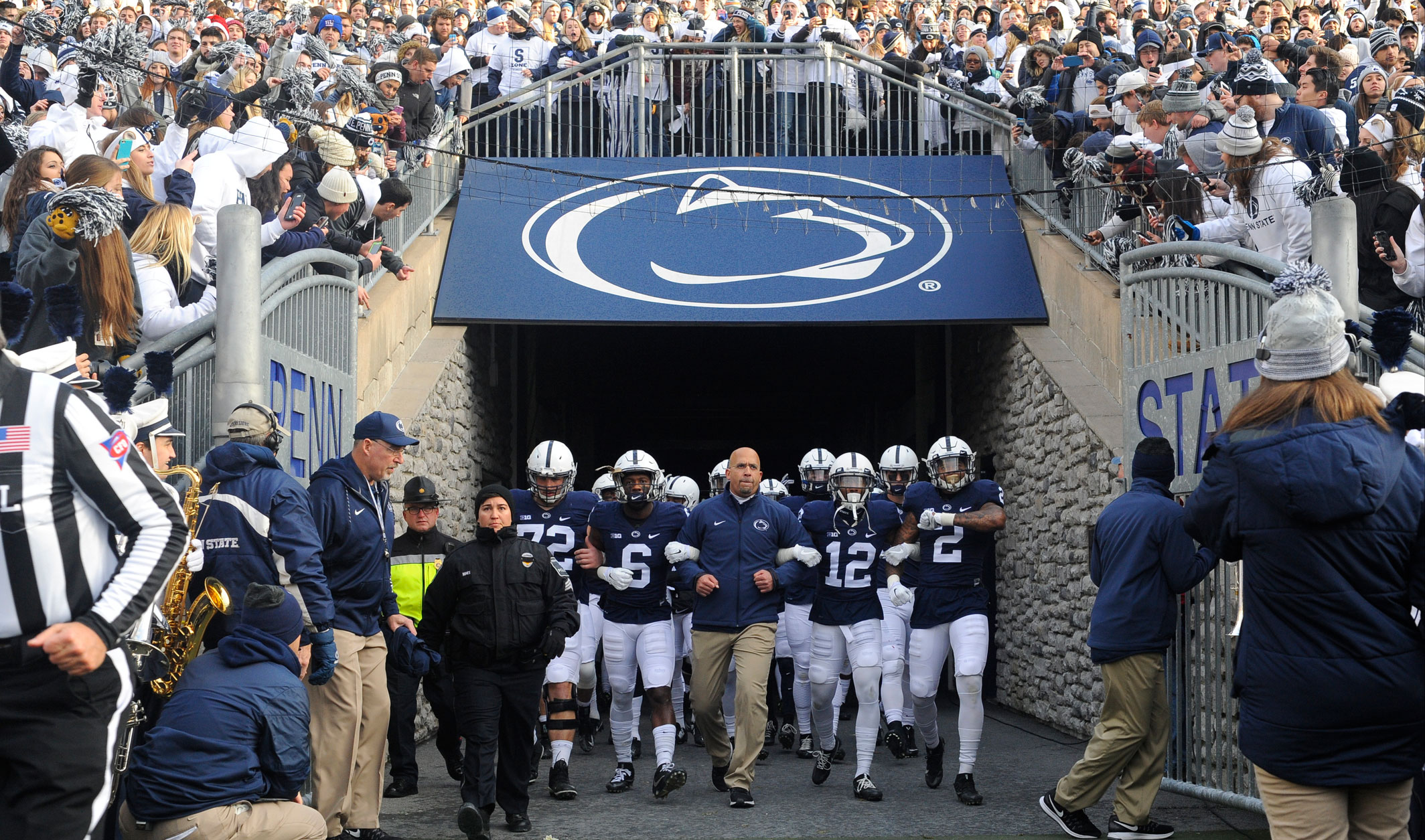 James Franklin linking arms with players as they emerge from the Beaver Stadium tunnel, photo by Randy Litzinger / AP News