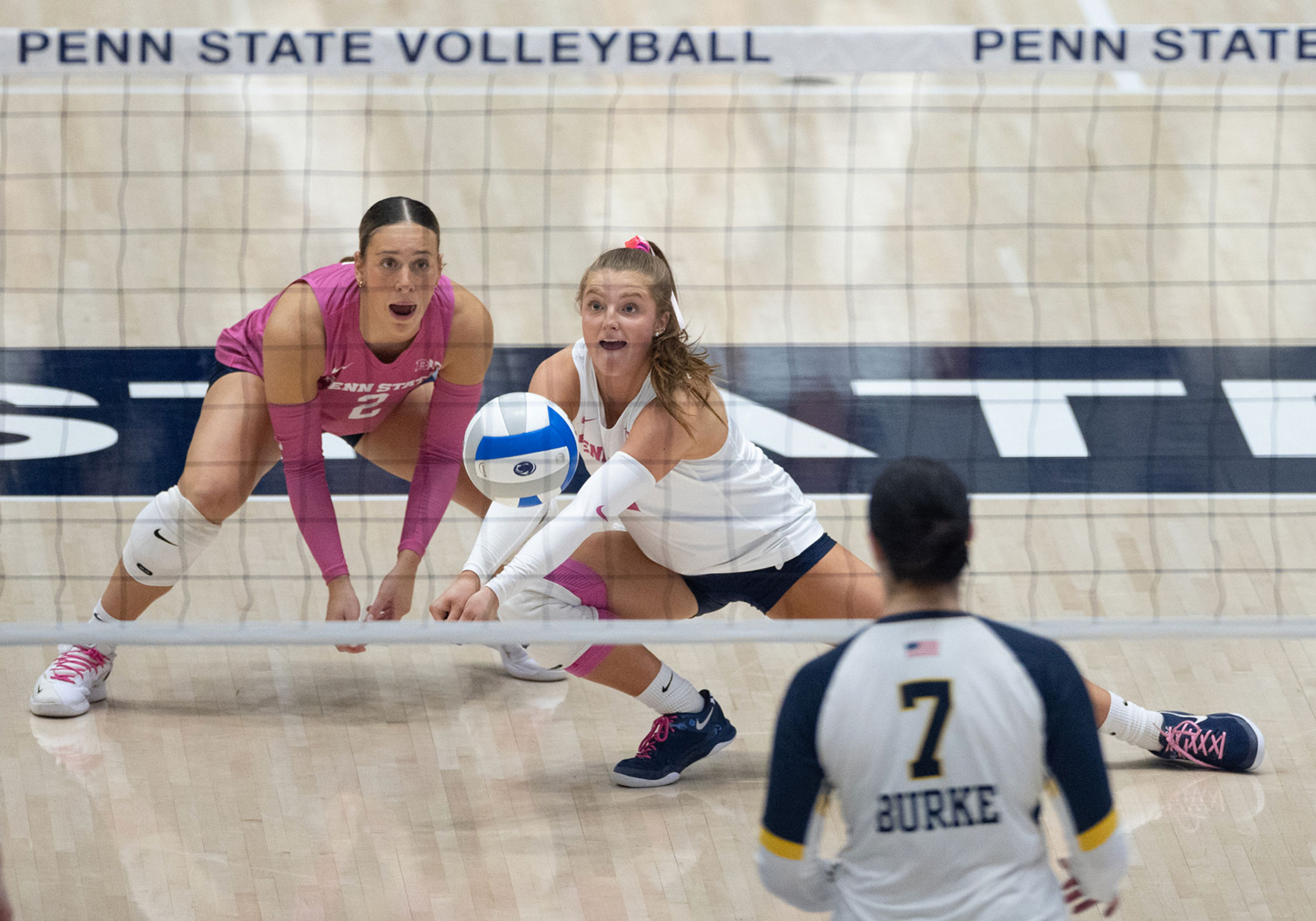 two Nittany Lion women's volleyball players in action, photo by Penn State Athletics