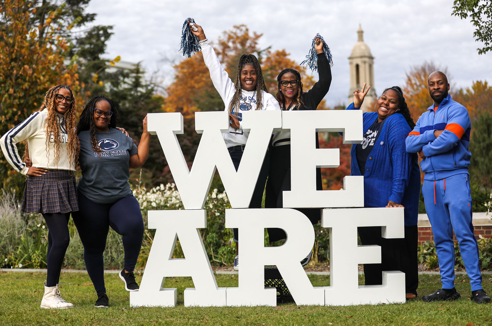 Black Alumni Reunion attendees posing on Hintz lawn with the We Are block letters, by Penn State Alumni Association