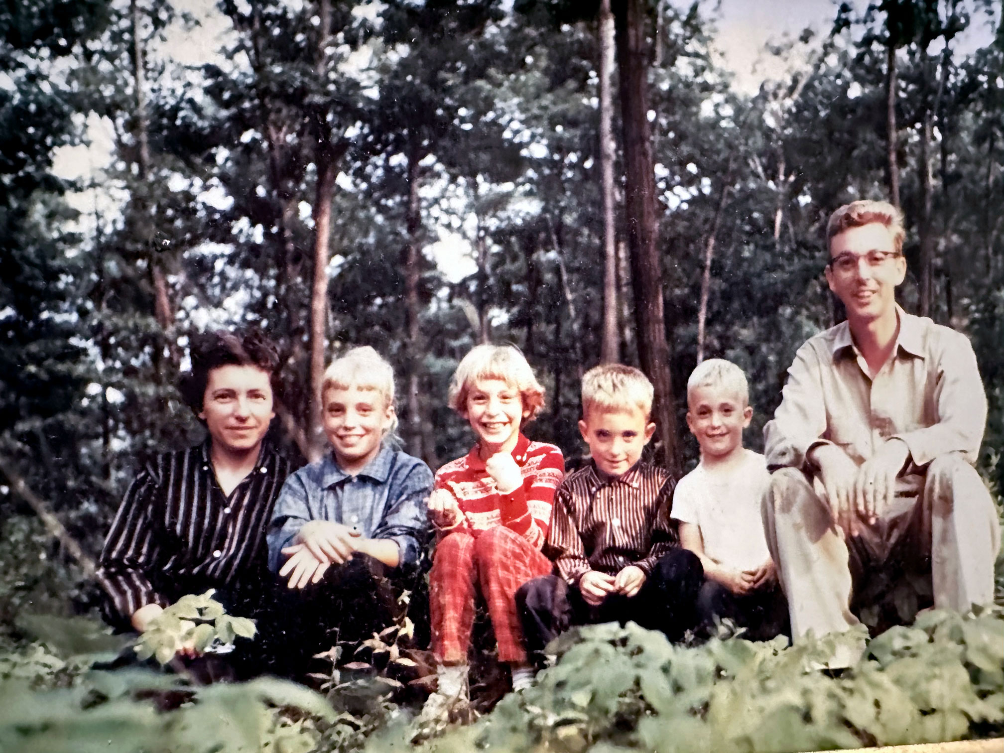 Hosler pictured with wife and children outside with trees in background, courtesy