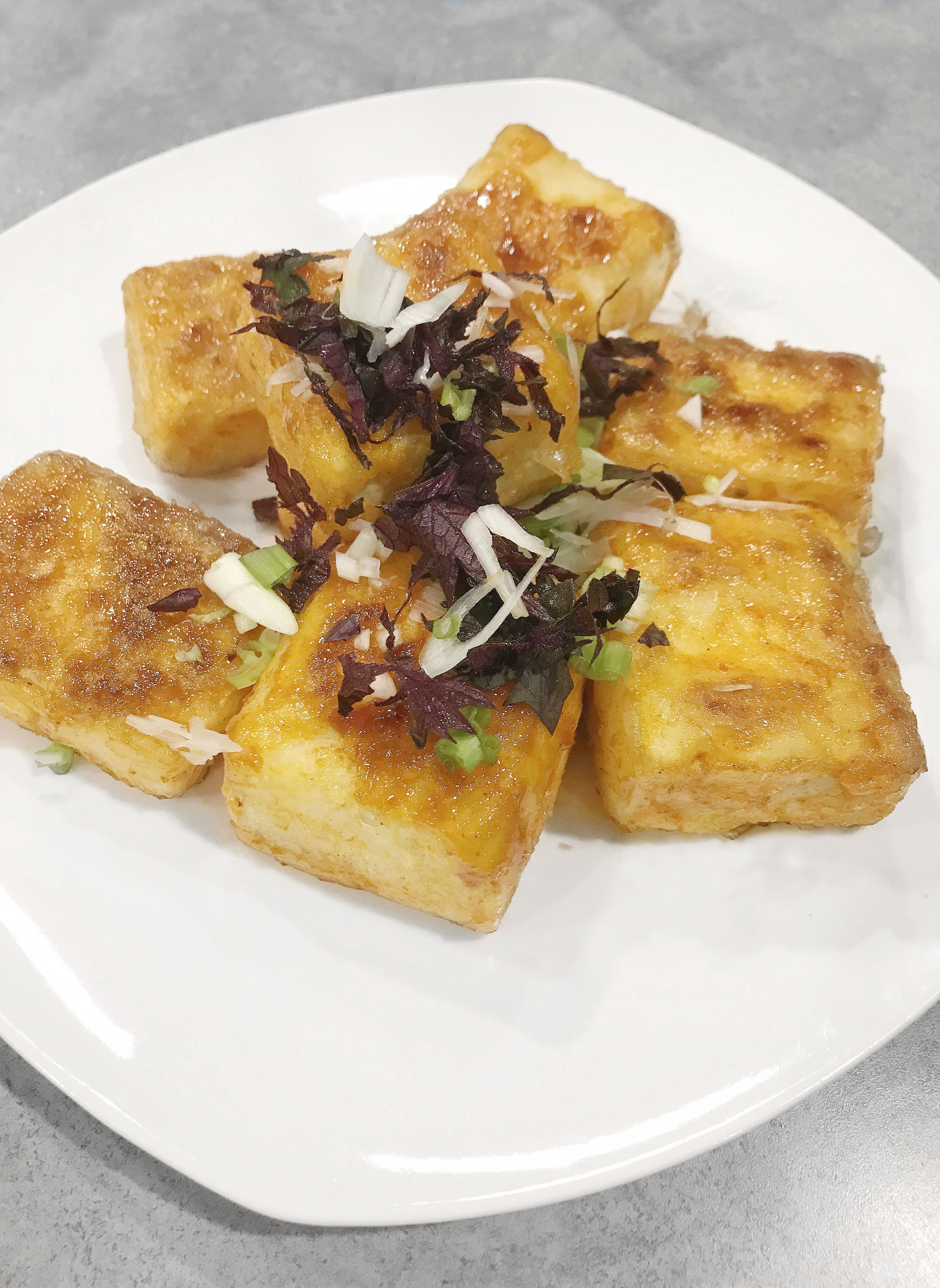 Crispy pan fried tofu seasoned with ginger, sake, and mirin, courtesy Anna Childe