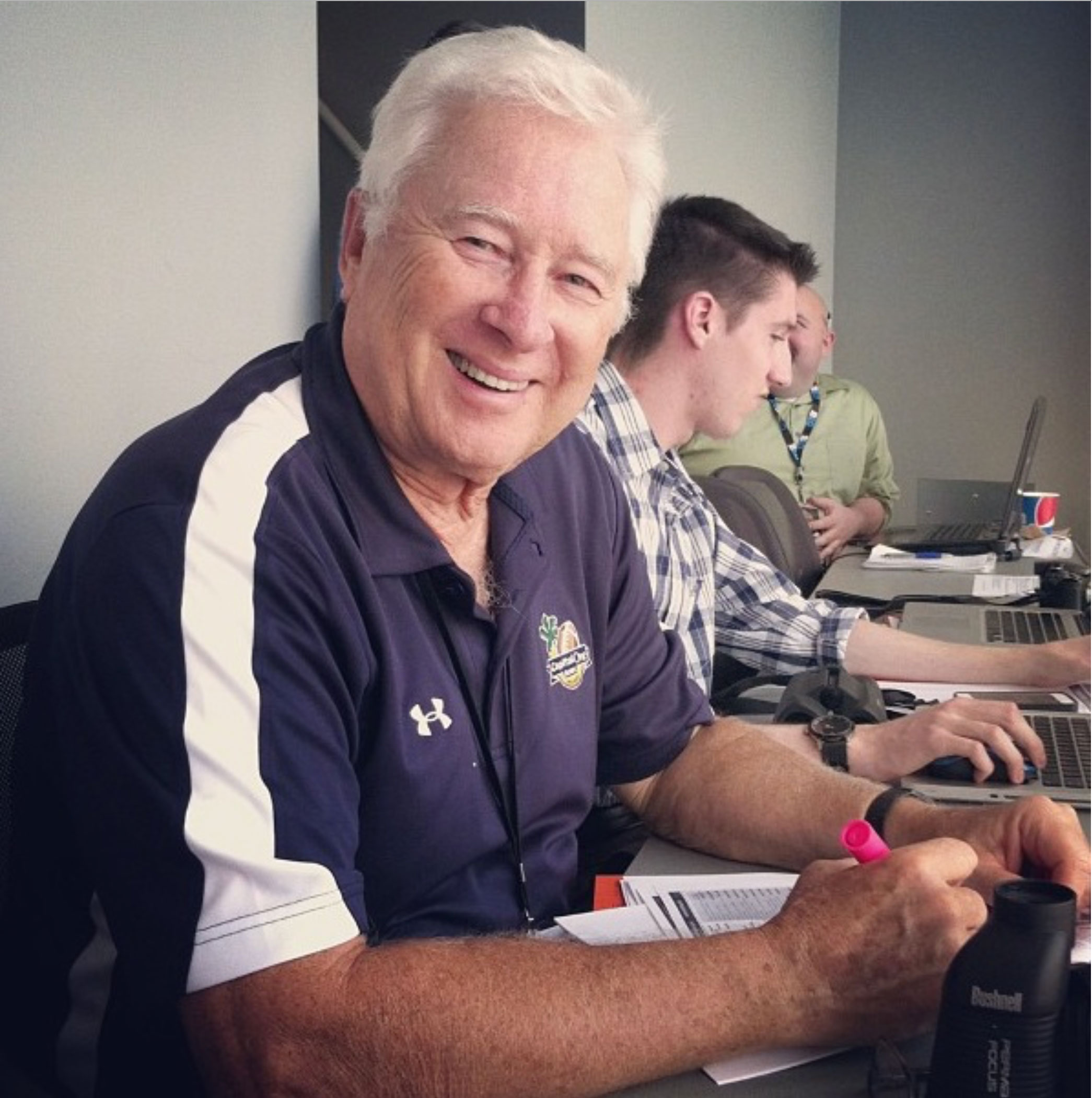 John Black pictured in press box with student writers, photo by PSAA