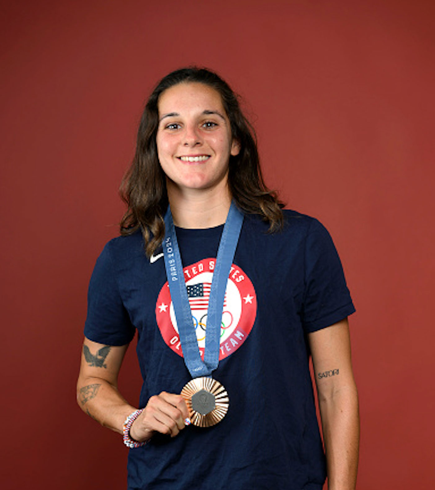 Canett holding up her bronze medal, photo by Kristy Sparow/Getty Images