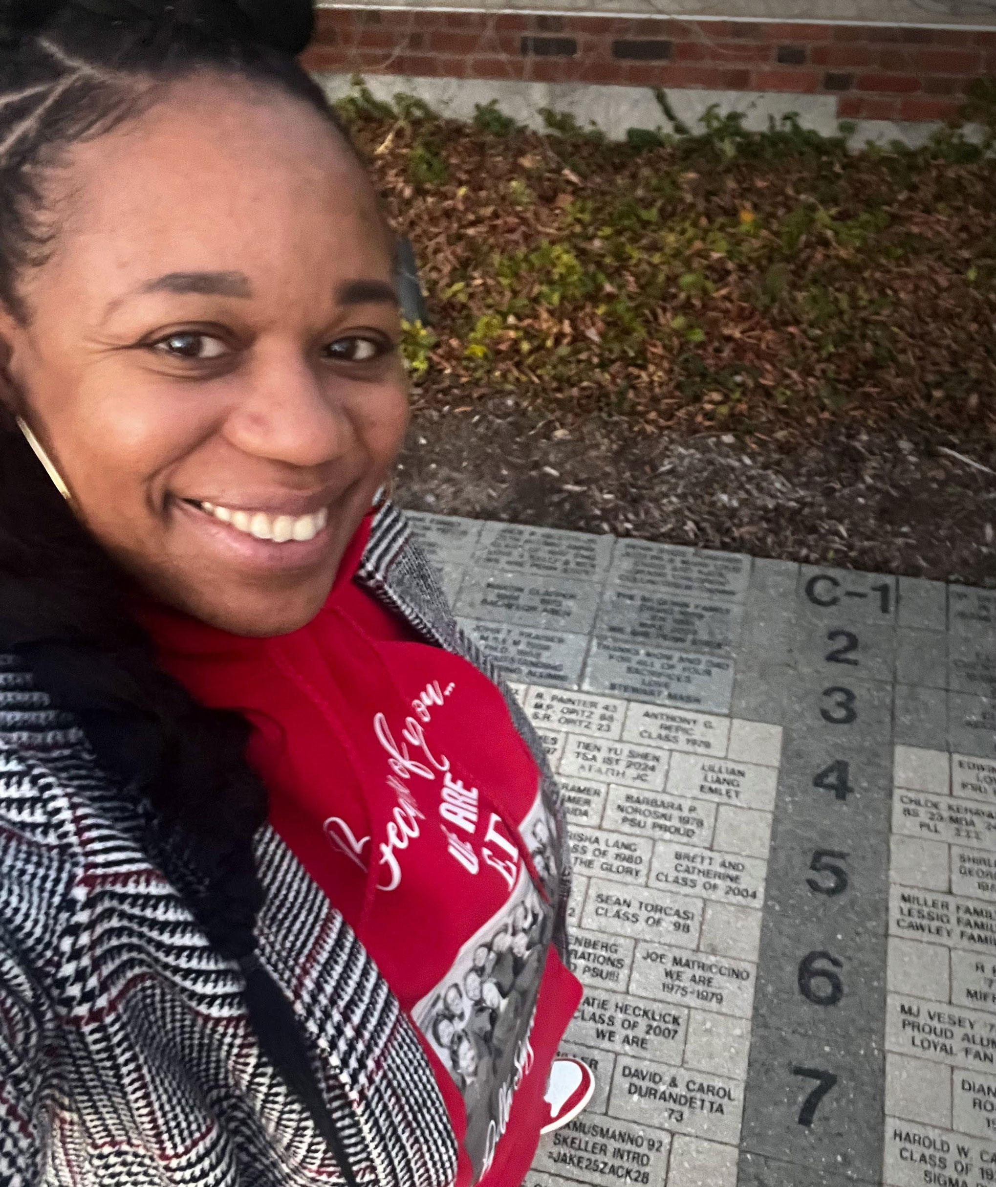 Reynolds taking a selfie with Delta Sigma Theta's commemorative pavers, courtesy