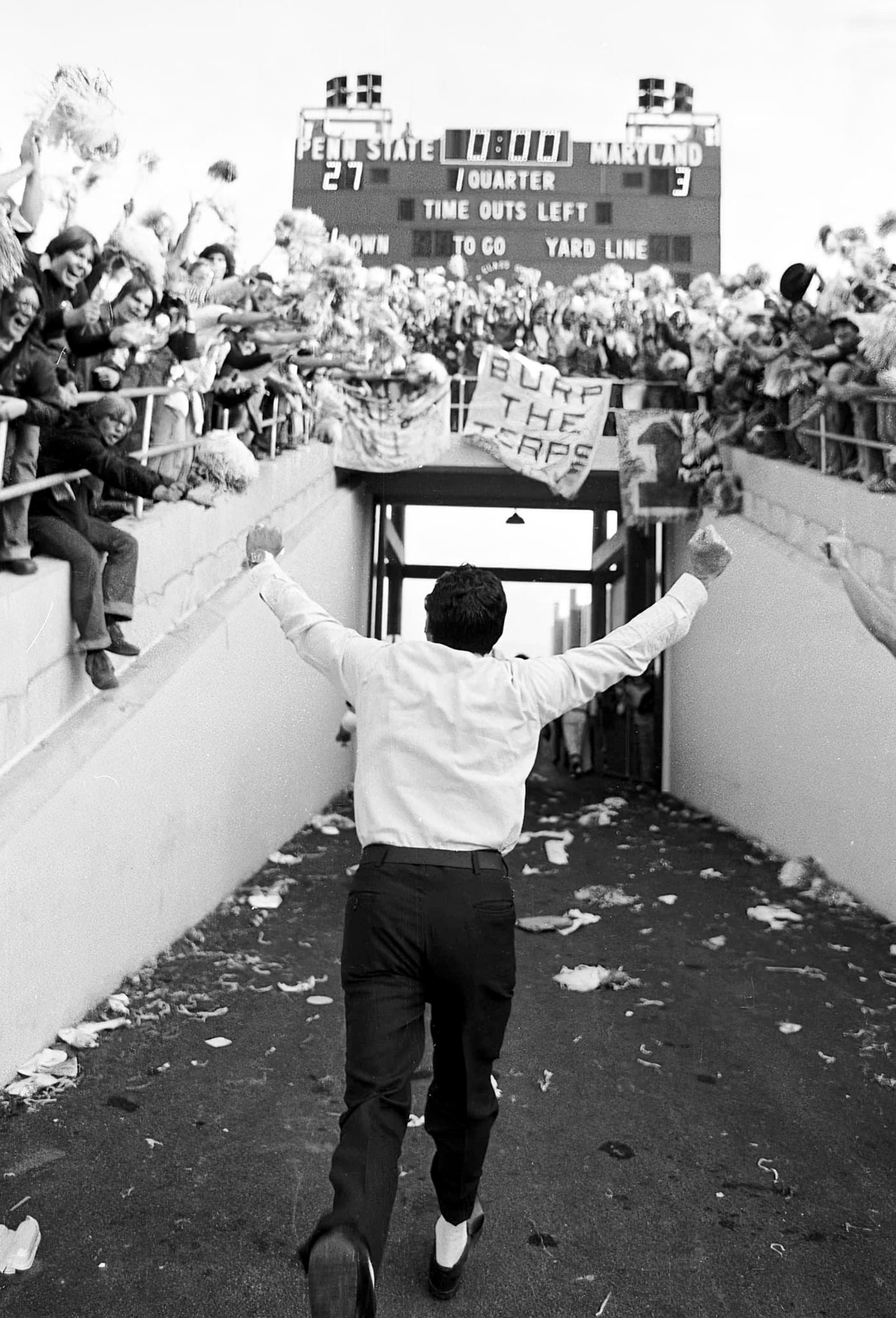 black and white photo of Joe Paterno walking into the tunnel at Beaver Stadium by Pat Little