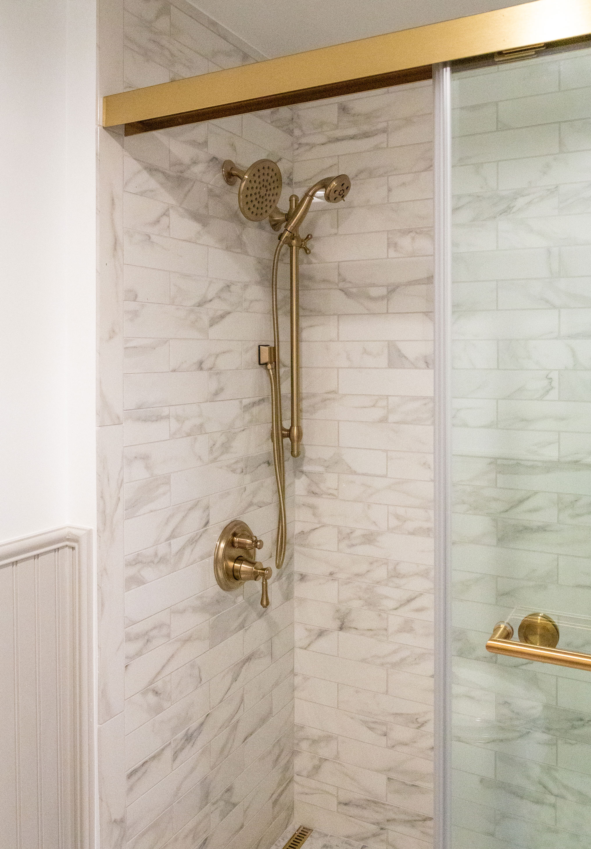 closeup of brass fixtures and marble tile in one of the showers in the Nittany Lion Inn, photo by Nick Sloff '92 A&A