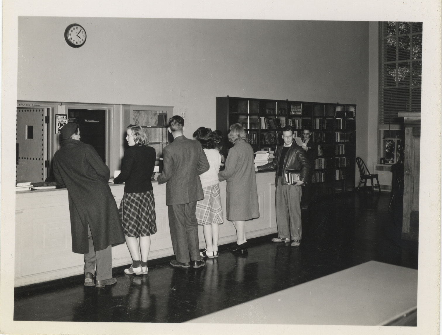 black and white photo of the library help desk by Penn State Libraries
