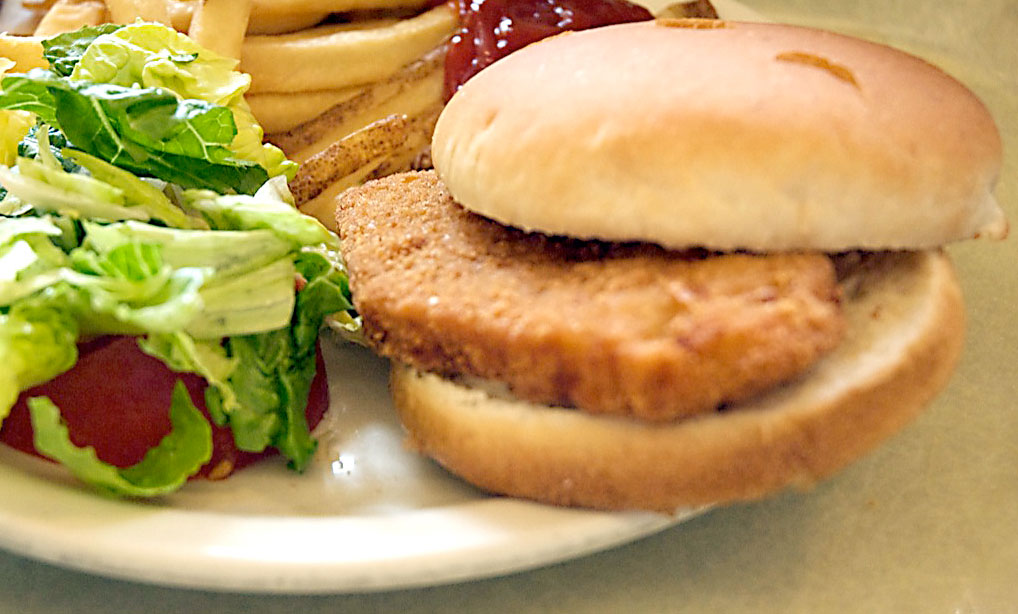 closeup of a chicken sandwich with salad and fries by Penn State Archives