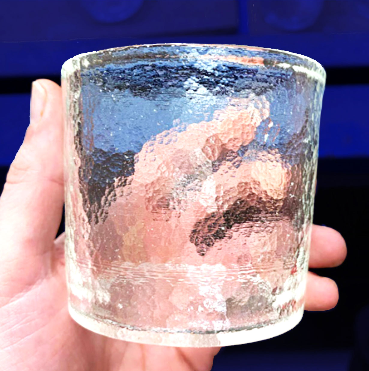 a closeup of a hand holding a LionGlass cup, by Penn State