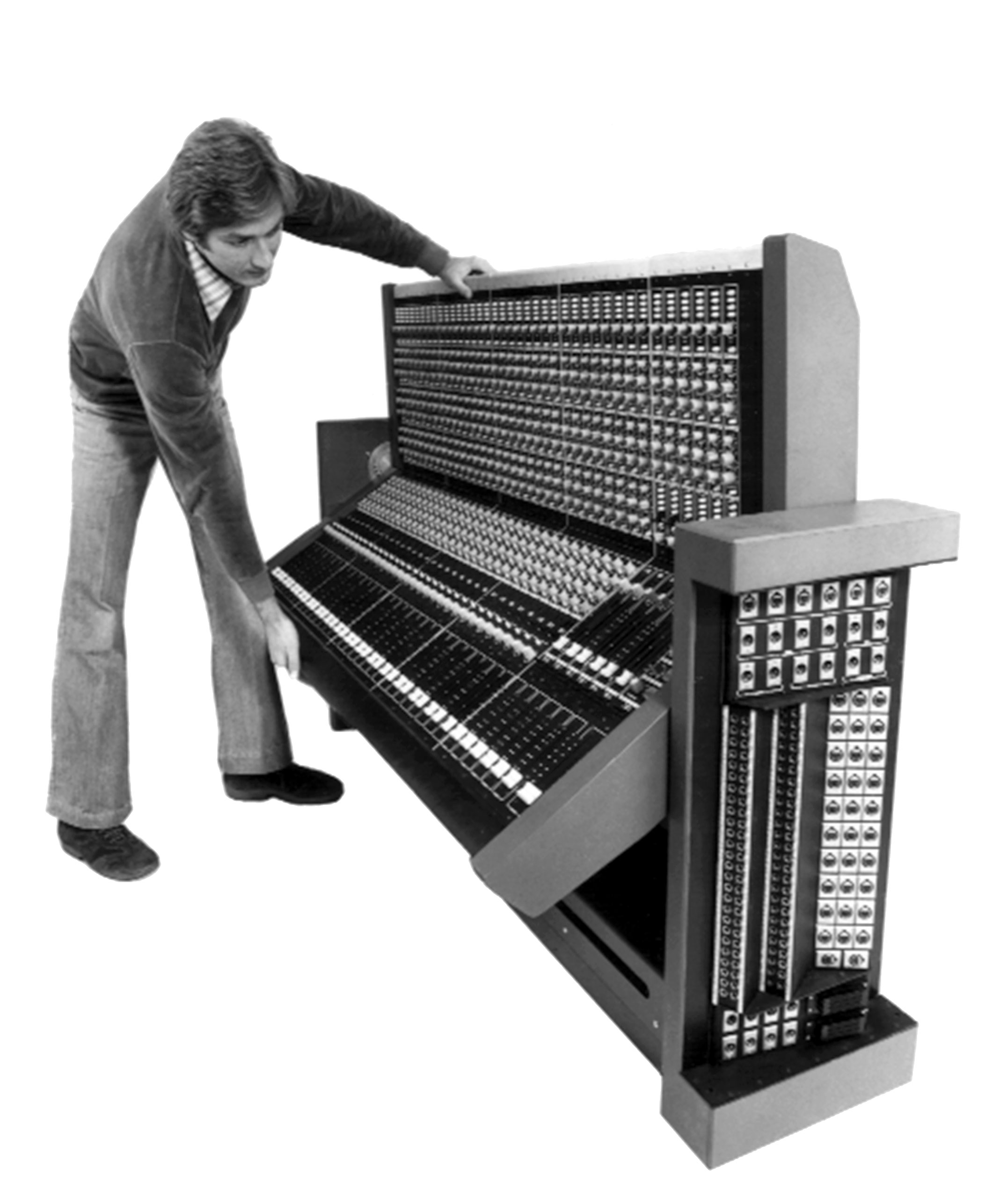 black and white photo of a man maneuvering a large piece of sound equipment, courtesy