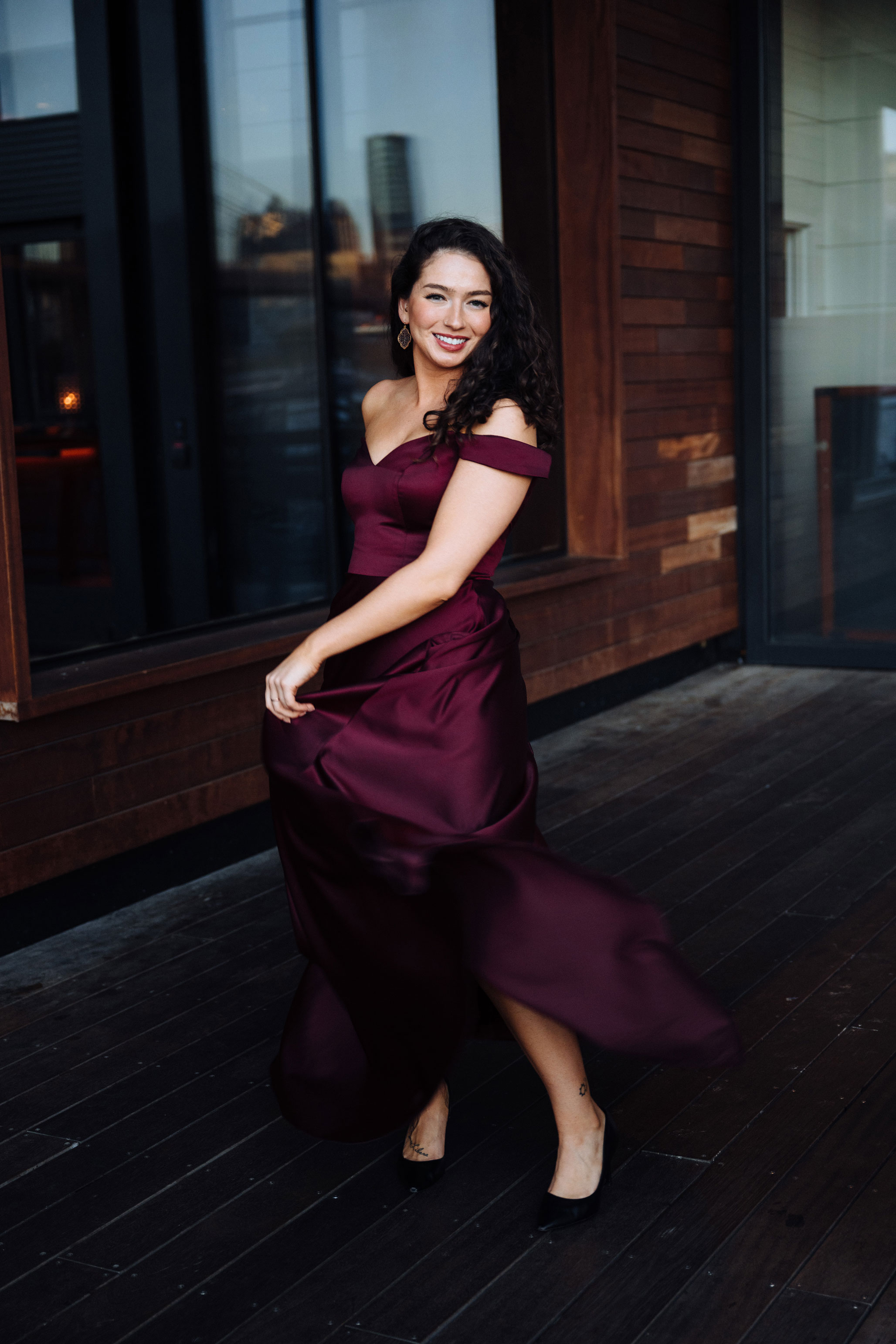 Lisa Rogali in floor-length wine-colored satin gown, courtesy