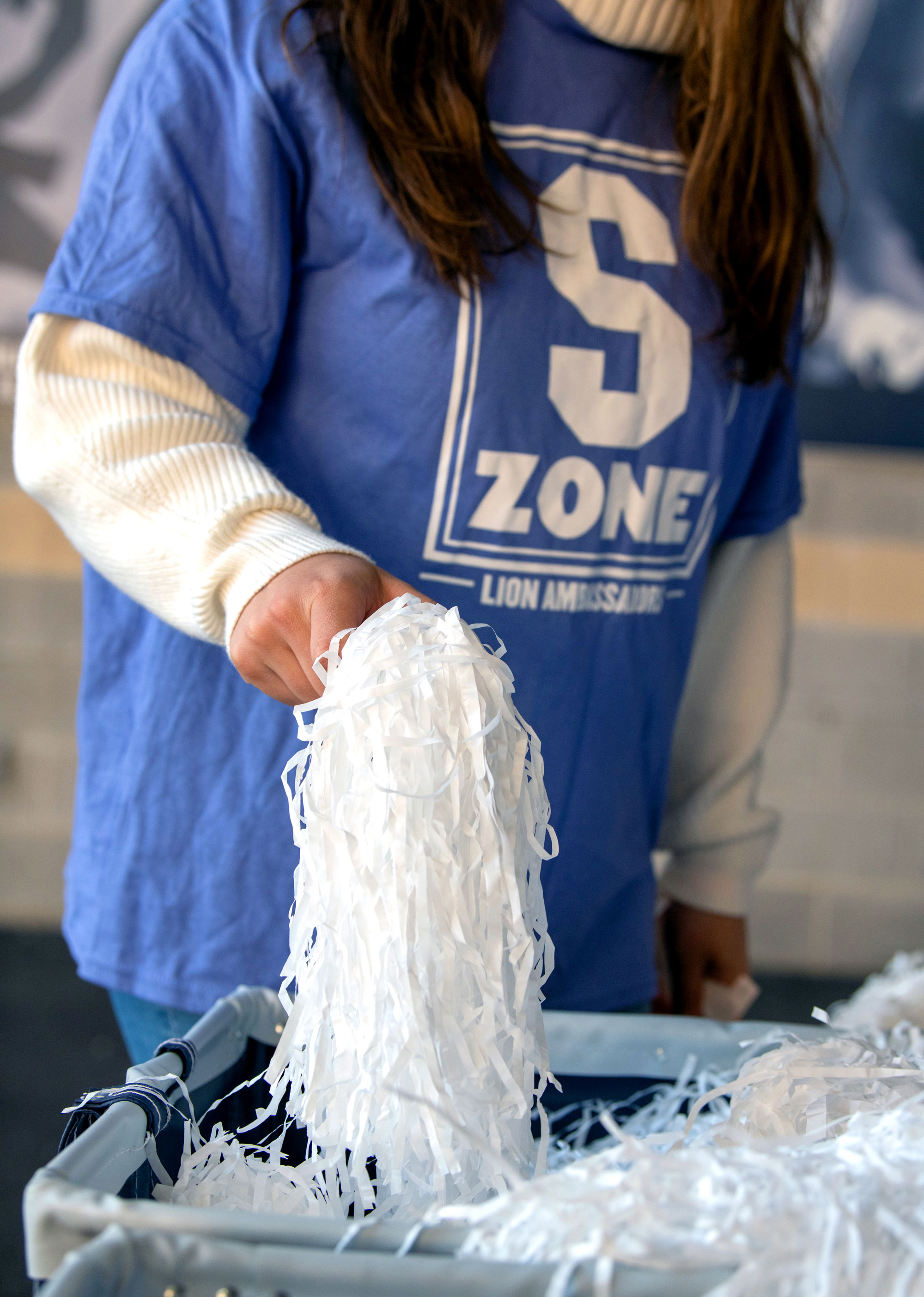 closeup of a student organizing shakers before a game, photo by Penn State Alumni Association