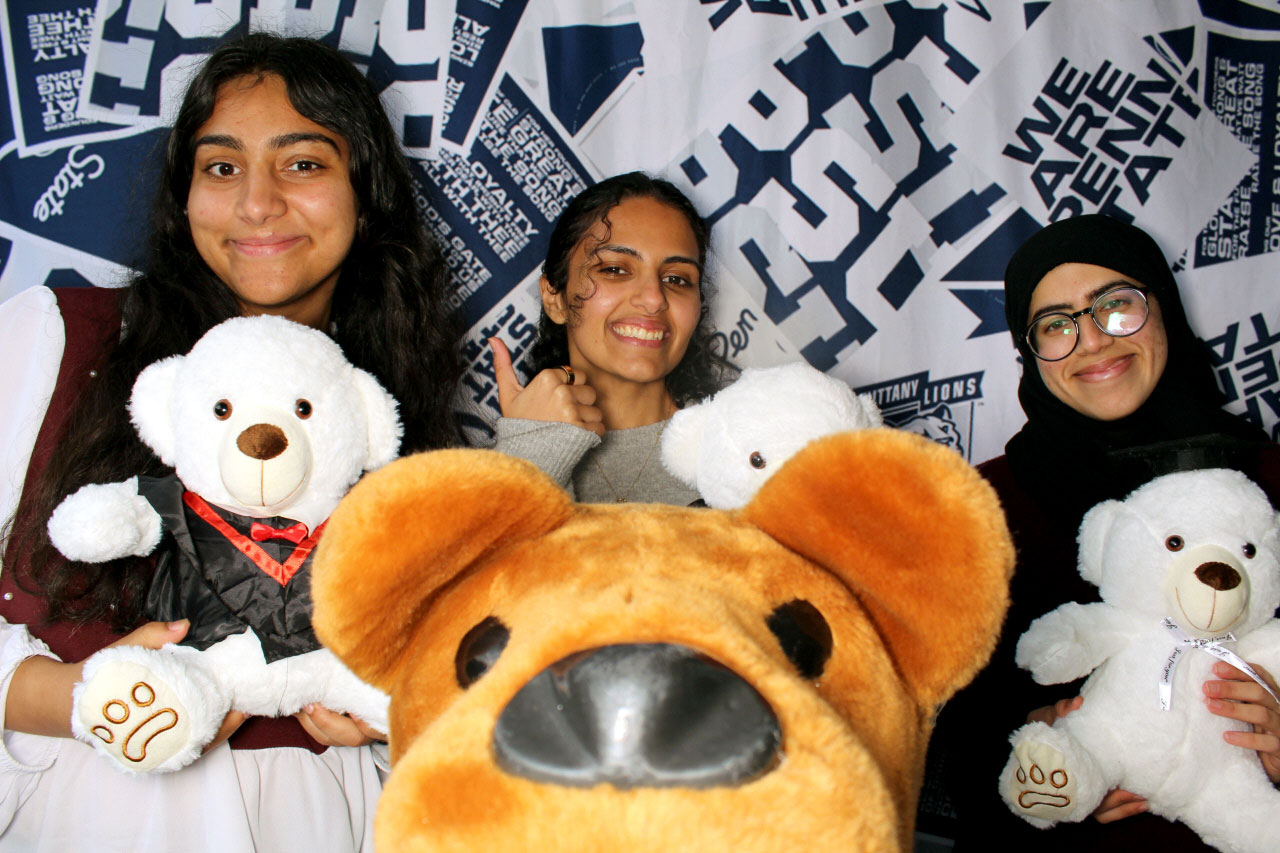 new grads with teddy bears and the Nittany Lion at Senior Sendoff 2026, by Penn State Alumni Association