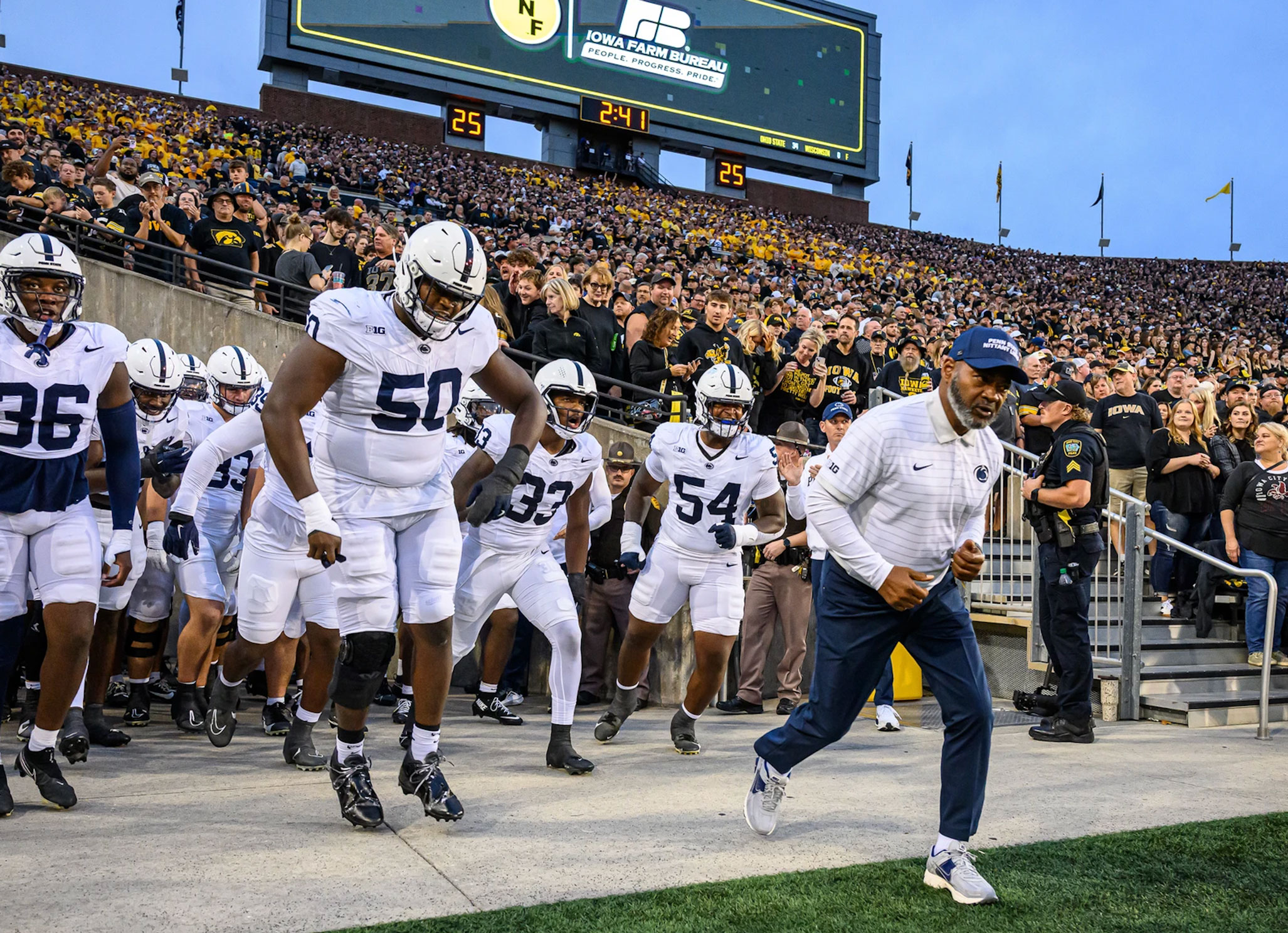 Smith and team running onto the field in Iowa, photo by Mark Selders/Penn State Athletics