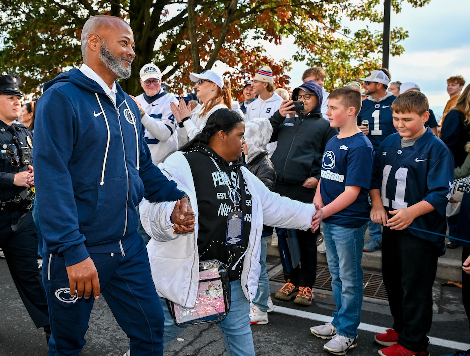 Smith walking with daughter, photo by Mark Selders/Penn State Athletics