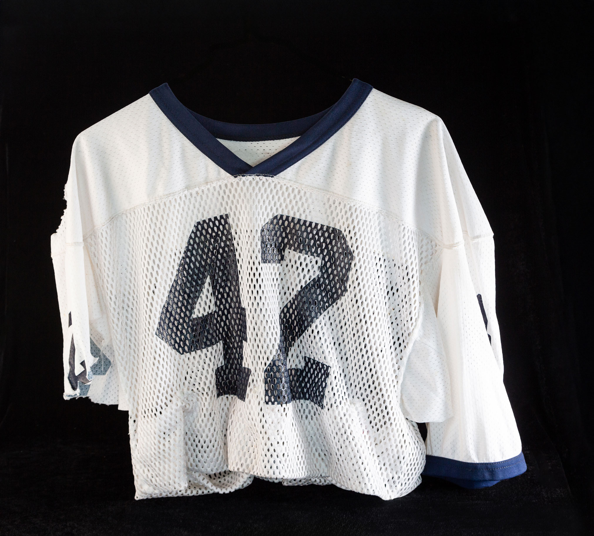 photo of a shredded white #42 jersey by Nick Sloff '92 A&A