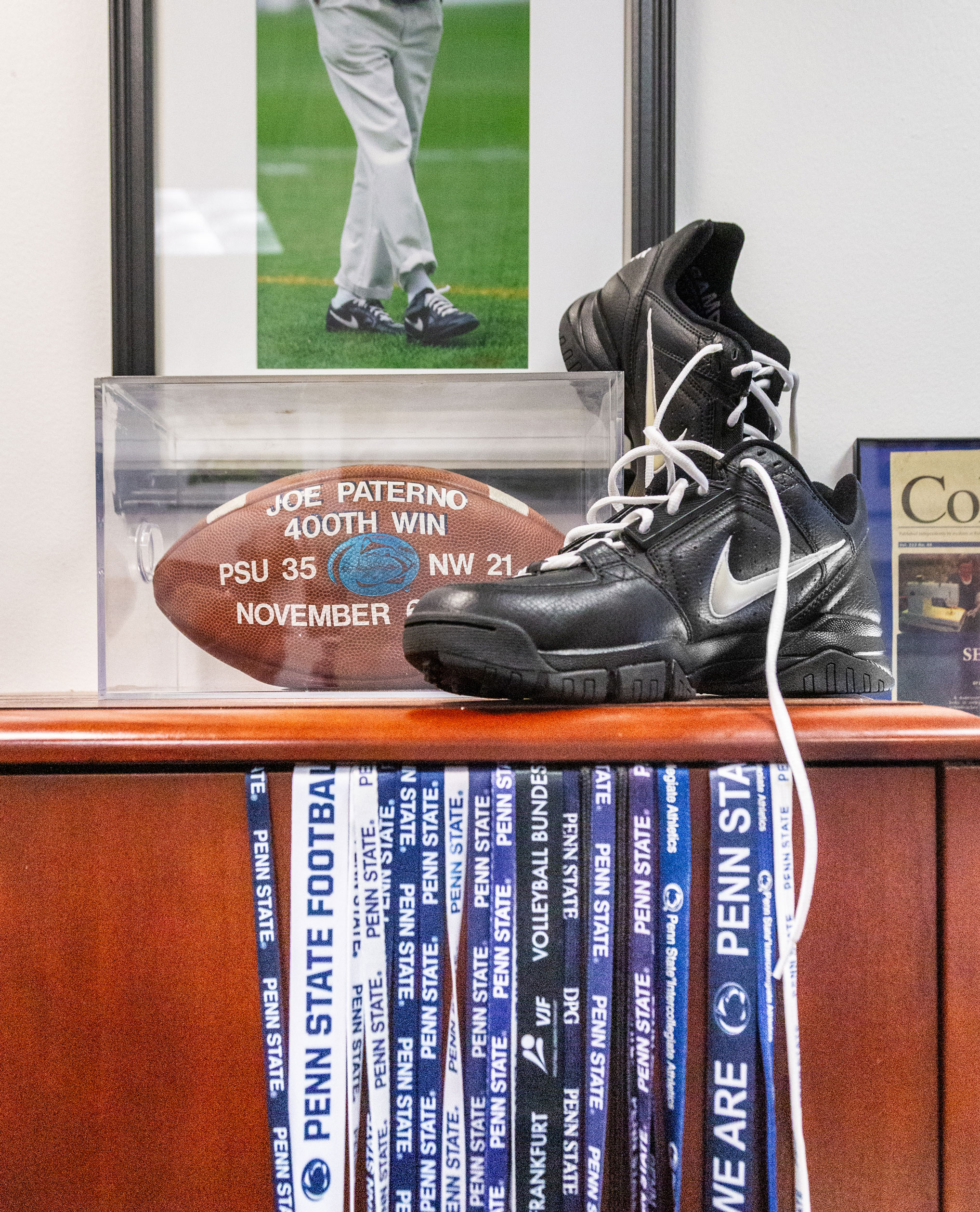 photo of Paterno shoes and football with Penn State Football lanyards hanging off a desk by Nick Sloff '92 A&A