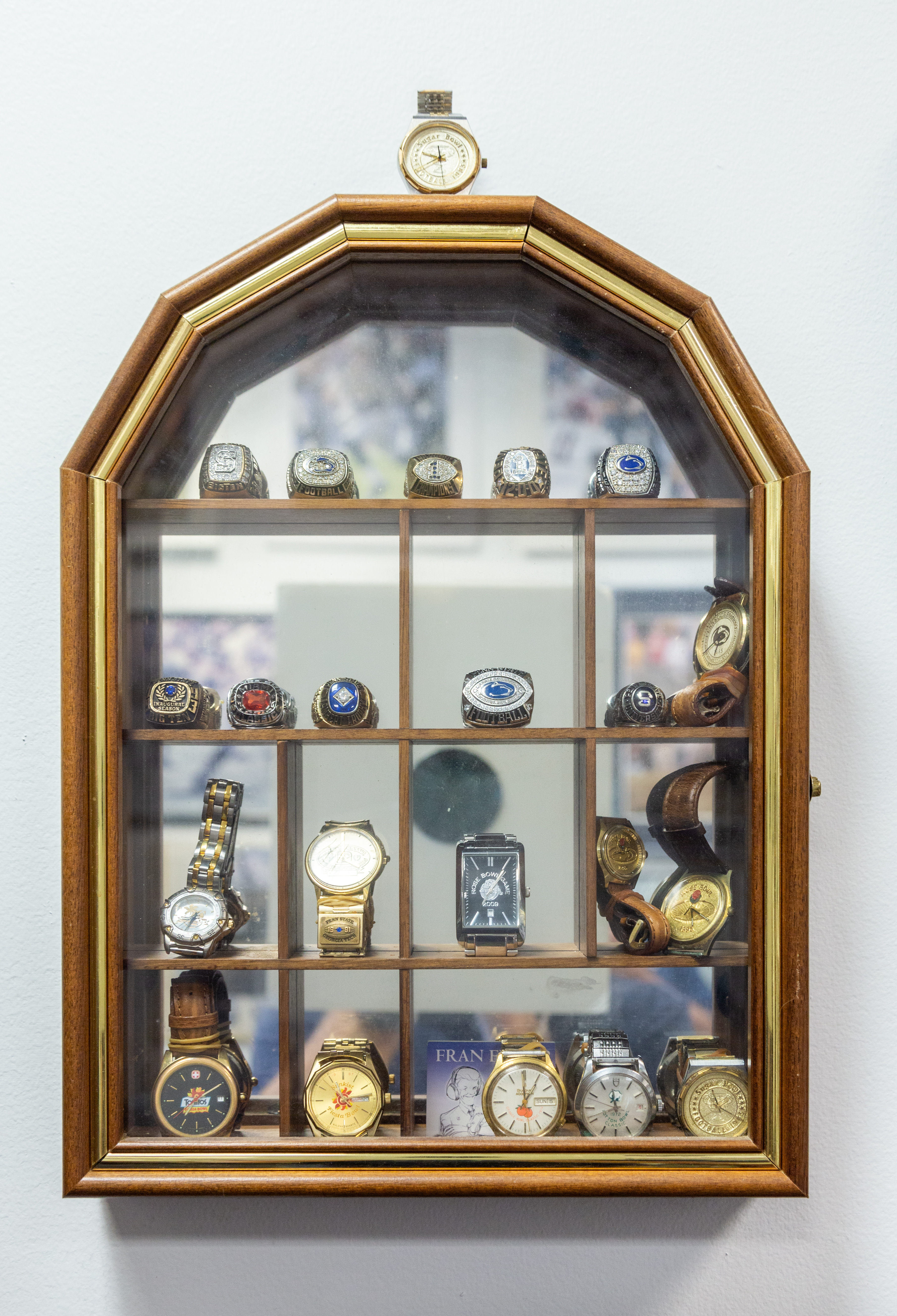 glass display case of watches and rings commemorating championships, photo by Nick Sloff '92 A&A