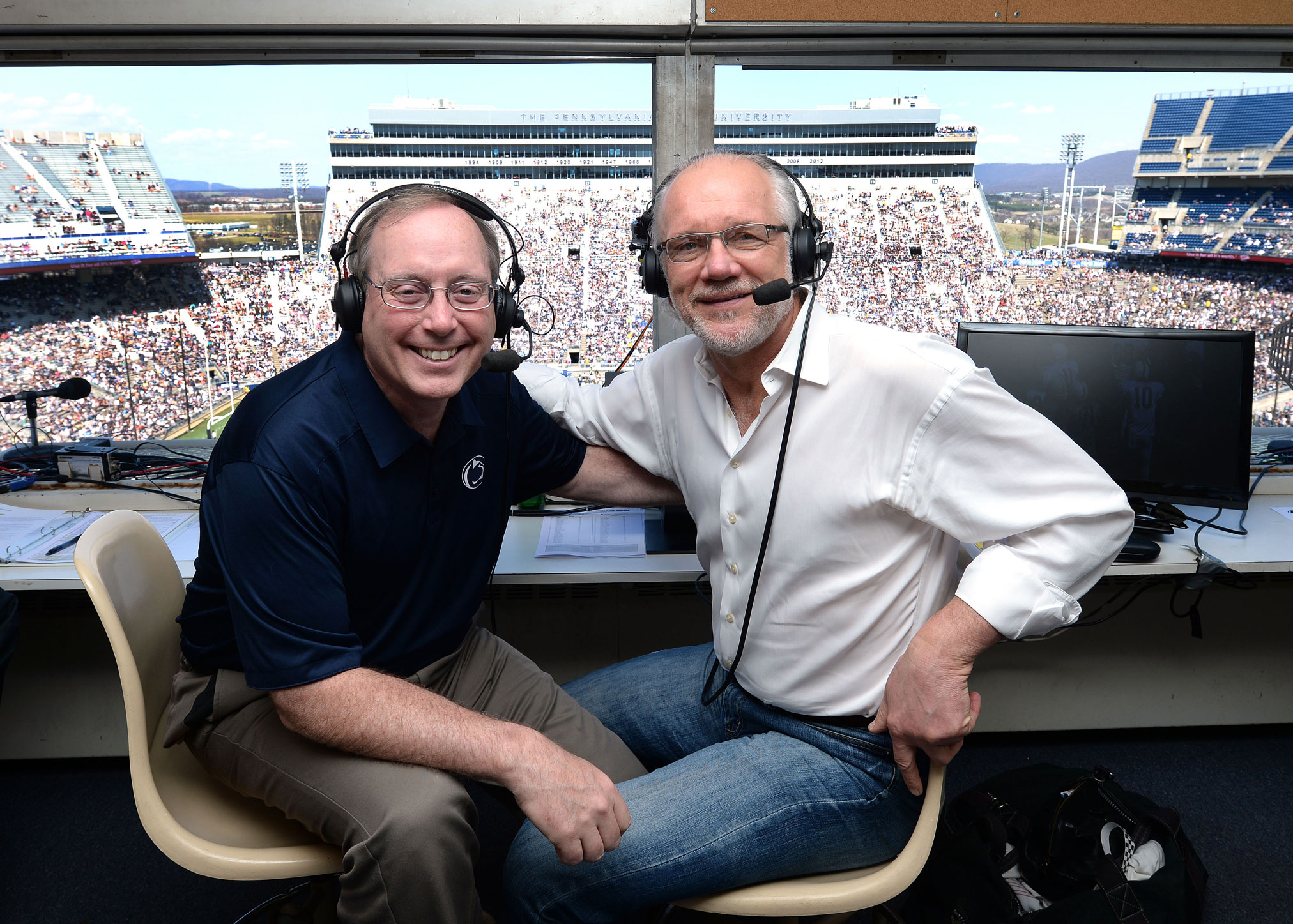 Manuel and Ham in Beaver Stadium broadcast booth by Steve Manuel '84 Lib, '92 MA Com