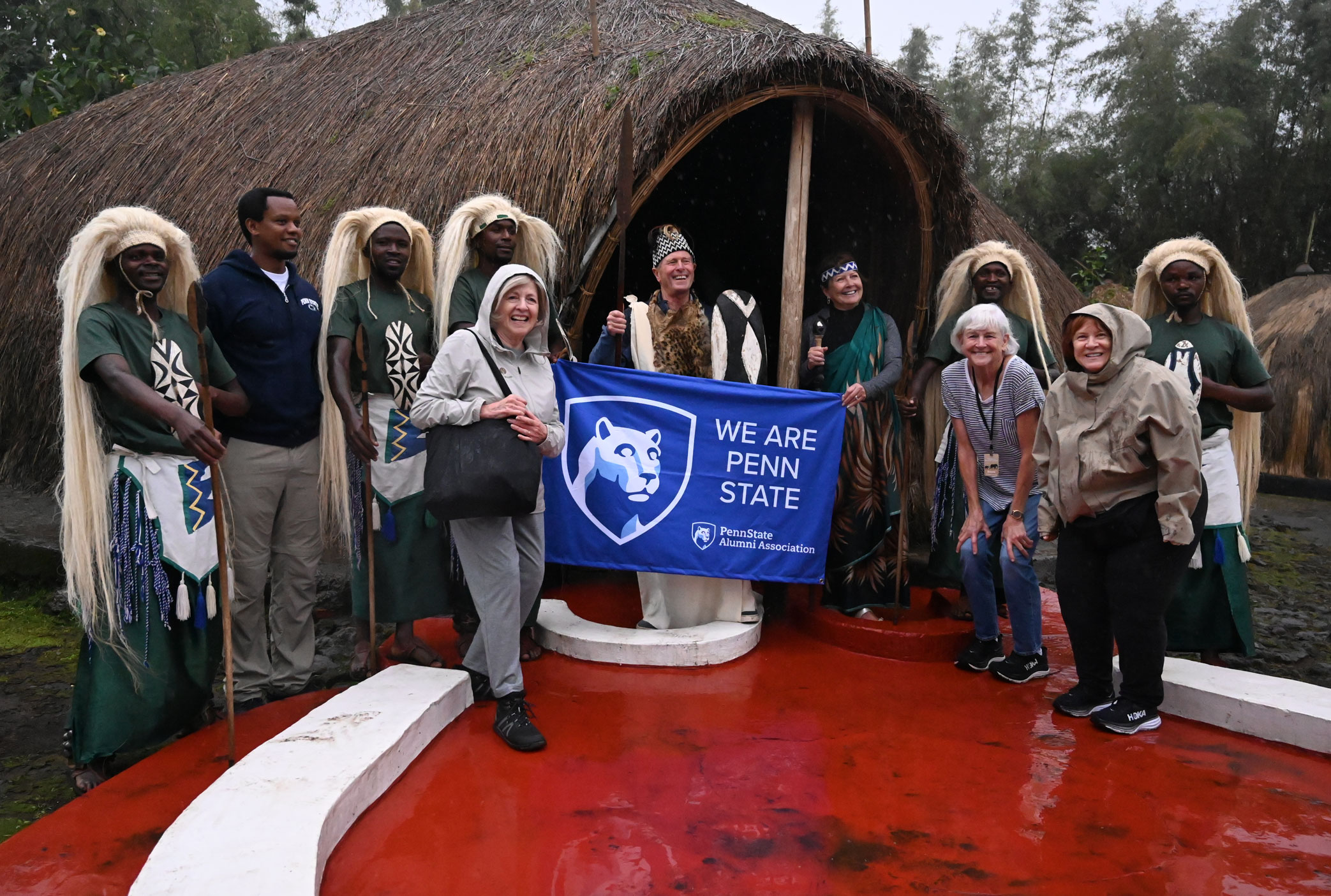 group photo of 2025 Alumni Travel trip in Tanzania with alums holding Penn State banner, by Penn State Alumni Association