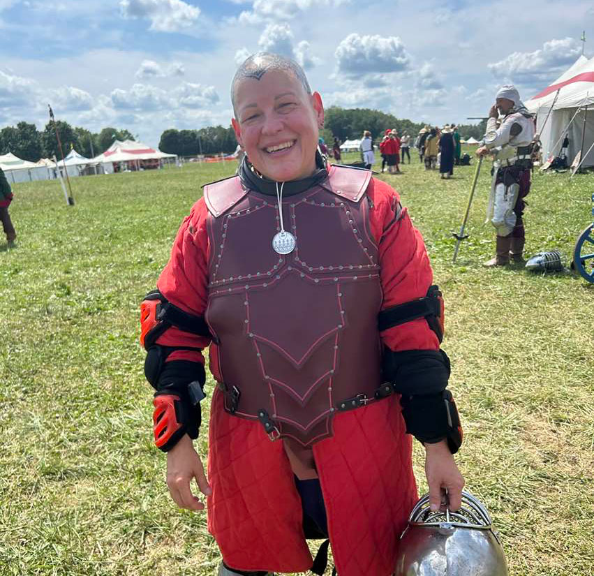 Tapia in fencing gear outside by Jena Soult.
